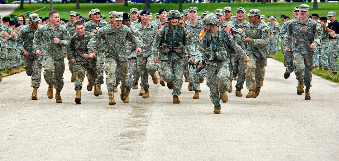 U.S. Army Sgt. Gomez, right, and Spc. Torres, left, are cheered on as they run down the final straight to the finish line of the 13-mile road march during the final event of the 14th Annual Warfighter Challenge on Fort Leonard Wood, Mo., Sept. 16, 2010. Gomez and Torres are assigned to Fort Richardson, Alaska.