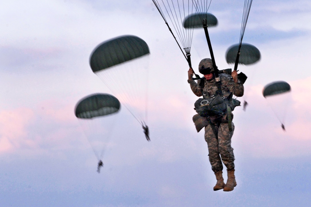 U.S. Army soldiers parachute after jumping from a C-130 Hercules aircraft during a joint forcible entry exercise over Fort Bragg, N.C., Sept. 12, 2010.