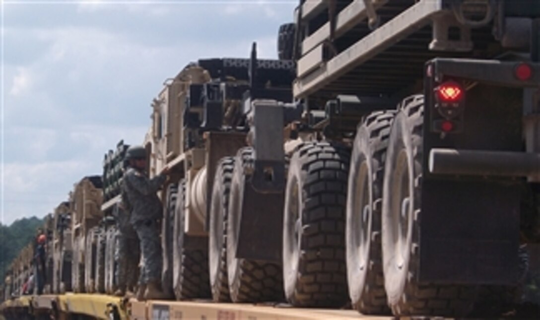 U.S. Army soldiers with the Iowa National Guard load vehicles onto railroad cars at Camp Shelby, Miss., for transport to the National Training Center at Fort Irwin, Calif., on Sept. 14, 2010.  