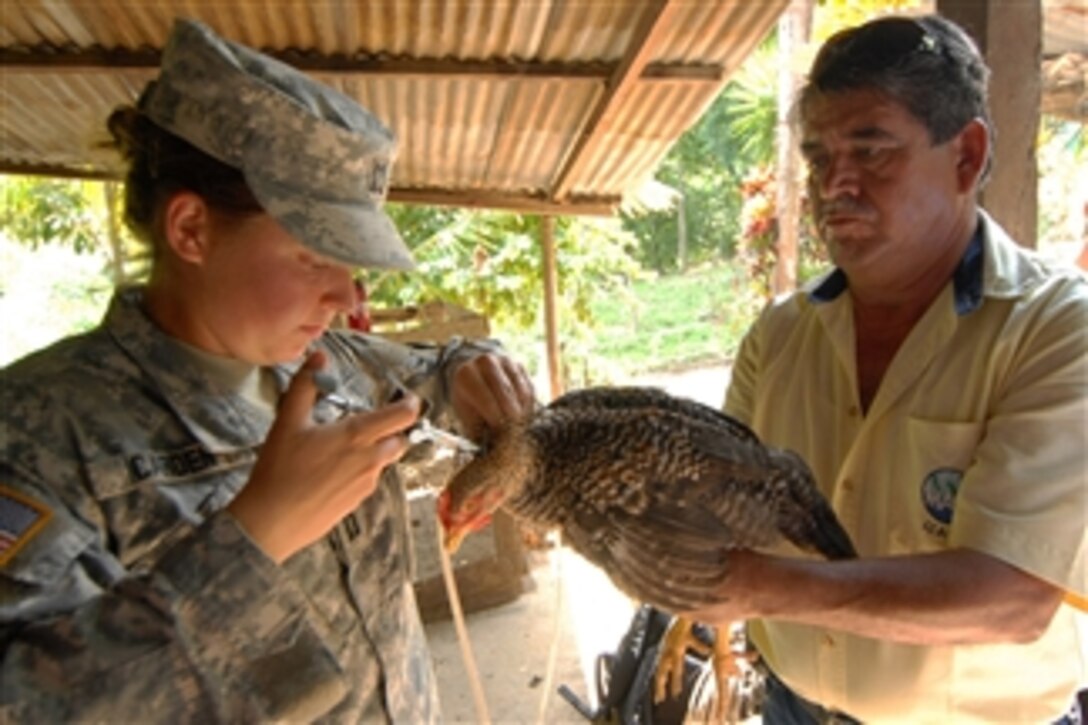 U.S. Army Capt. Rebecca Carden (left), a veterinarian with South Plains Veterinary Services, Fort Sam Houston, Texas, embarked aboard the multipurpose amphibious assault ship USS Iwo Jima (LHD 7) vaccinates a chicken during a veterinary mission in Puerto Barrios, Guatemala, on Sept. 8, 2010.  The ship supported Continuing Promise 2010, a humanitarian civic assistance mission.  