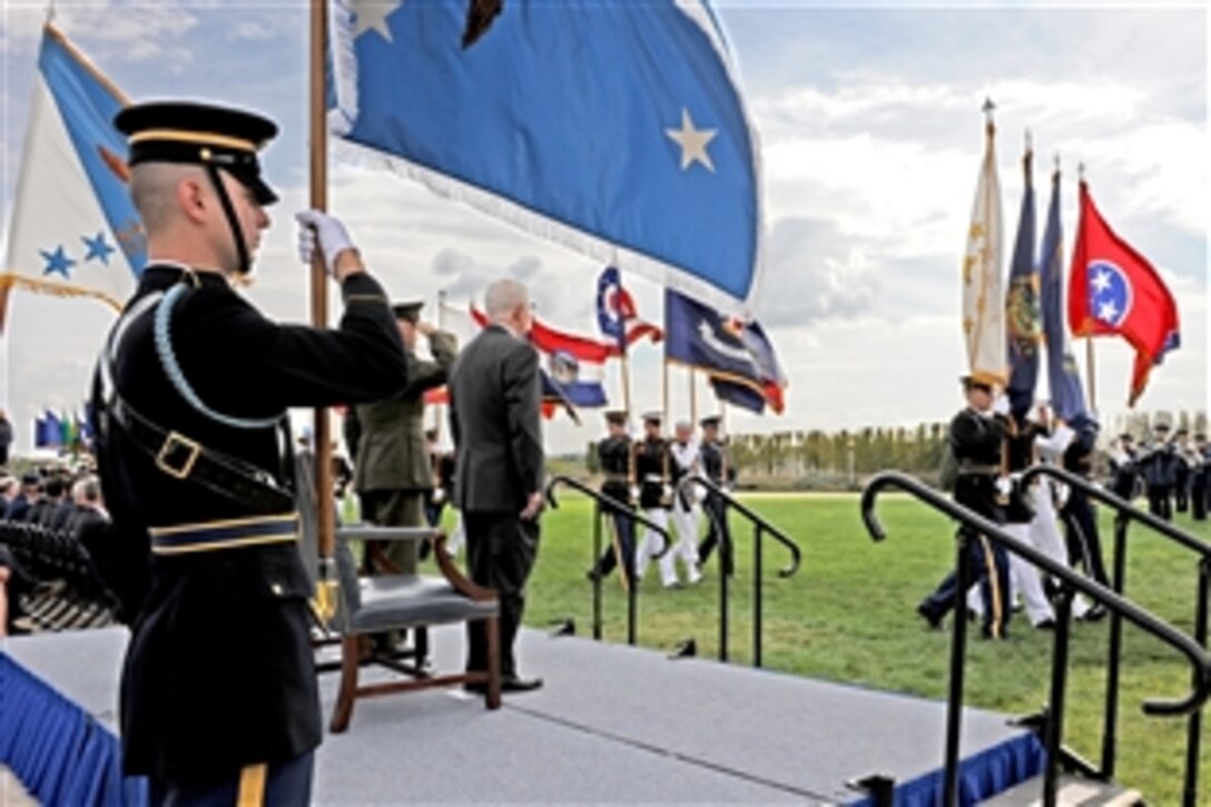 Defense Secretary Robert M. Gates watches and Marine Gen. James Cartwright, vice chairman of the Joint Chiefs of Staff,  salutes as the flags of the states and territories of the United States pass in review during Pentagon ceremonies  held in observance of National POW/MIA Recognition Day, Sept. 17, 2010.