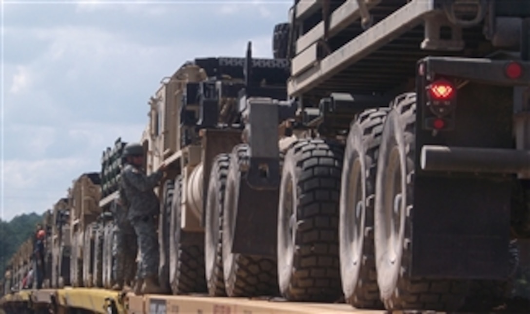 U.S. Army soldiers with the Iowa National Guard load vehicles onto railroad cars at Camp Shelby, Miss., for transport to the National Training Center at Fort Irwin, Calif., on Sept. 14, 2010.  