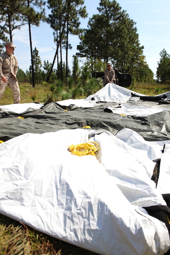 Marines with the 22nd Marine Expeditionary Unit dismantle a tent at the conclusion of a communications exercise aboard Camp Lejeune, N.C., Sept. 17, 2010. During the training evolution Marines set up a forward command element and secured a communication line back to the rear command element.