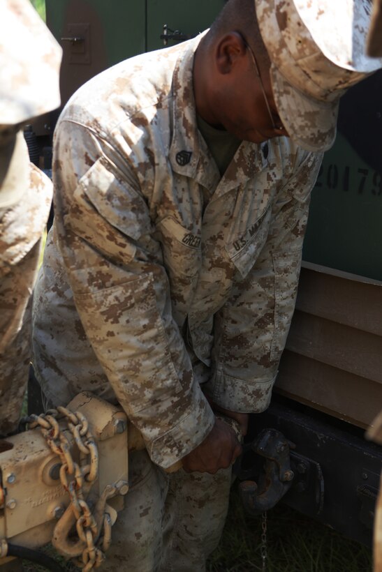 Staff Sergeant Damien N. Green, right,  radio chief with the 22nd Marine Expeditionary Unit and Prince Georges, Md., native, attaches a trailer to a Humvee during a communications exercise aboard Camp Lejeune, N.C., Sept. 17, 2010. During the training evolution Marines set up a forward command element and secured a communication line back to the rear command element.