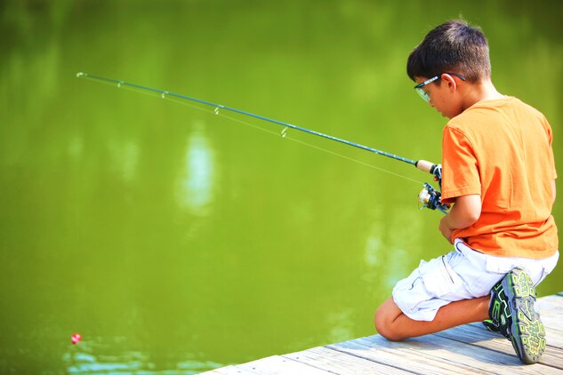 Victor Salazar, a military dependent and fishing enthusiast, prepares for the big catch after lowering his line into the water during the first Fun Family Fishing Day at Orde Pond aboard Marine Corps Base Camp Lejeune, Sept. 18.  Service members, families and friends gathered at the pond for a day of food, fun and fishing in the sun.