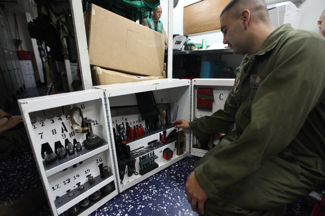Lance Cpl. Andrew Tarin with Marine Medium Tiltrotor Squadron 266 (Reinforced), 26th Marine Expeditionary Unit, sorts through his tools in the squadron's flight equipment shop aboard USS Kearsarge in the Red Sea, Sept. 18, 2010. 26th Marine Expeditionary Unit deployed aboard the ships of Kearsarge Amphibious Ready Group in late August responding to an order by the Secretary of Defense to support Pakistan flood relief efforts.
