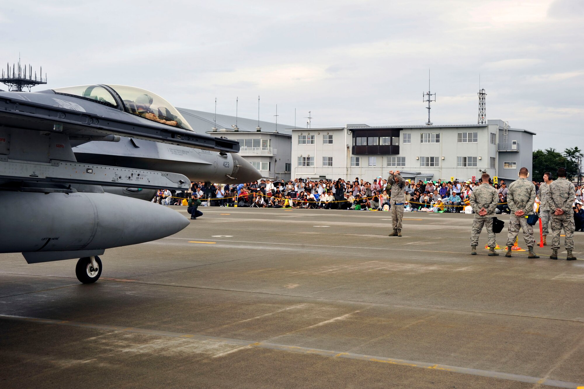U. S. Air Force Senior Airman Jessie Arenal, 35th Aircraft Maintenance Squadron, marshals an F-16 Fighting Falcon, flown by Capt. Kyle Martin, 13th Fighter Squadron pilot, onto the Misawa Air Base, Japan, flightline during the Misawa Air Festival, Sept. 19, 2010. The air festival is held annually to strengthen Japanese and American relations. (U.S. Air Force Photo/Tech. Sgt. Russell McBride) (Released)