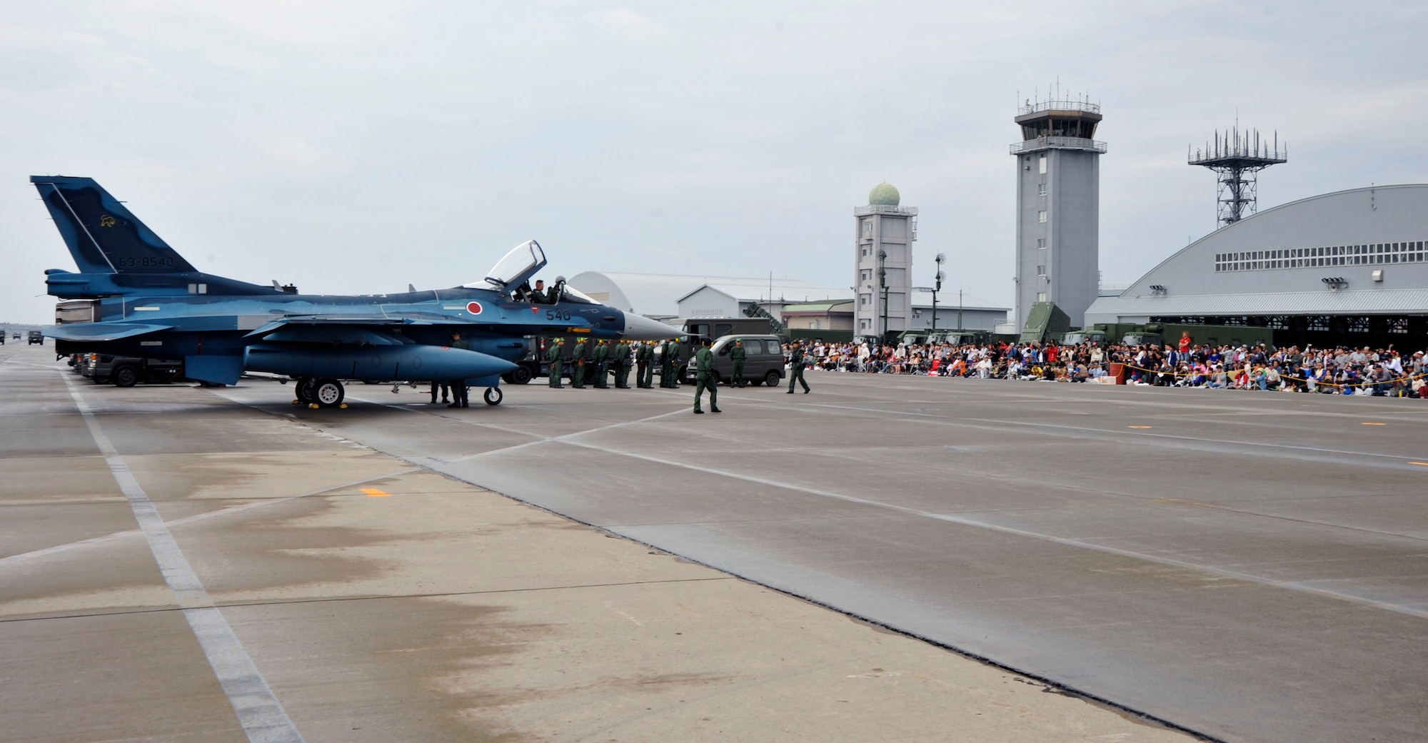 A crowd watches as a Japan Air Self-Defense Force F-2 aircraft taxis onto the runway at Misawa Air Base, Japan, during the annual air festival, here, Sept. 19, 2010. To kick off the Misawa Air Festival, the F-2 performed a bi-lateral flyby with a U.S. Air Force F-16 Flying Falcon. (U.S. Air Force Photo/Tech. Sgt. Russell McBride) (Released)