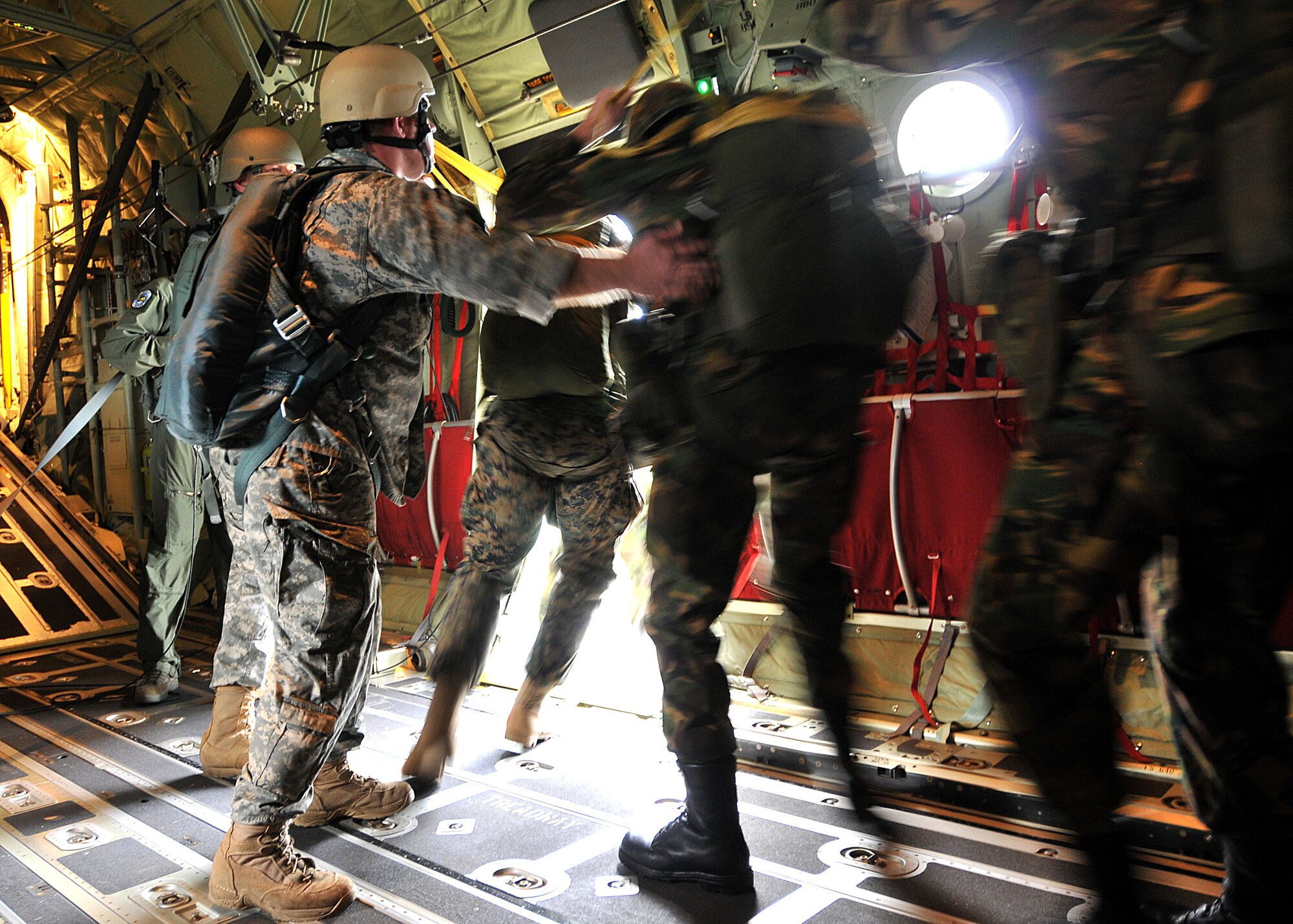 Paratroopers from five nations jump out of a C-130J Hercules assigned to the 37th Airlift Squadron, Ramstein Air Base, Germany Sept. 18, 2010.
Approximately 700 Dutch, German, British and American paratroopers participated in the event in Ginkelese Heide, Holland as part of a ceremony commemorating the 66th anniversary of Operation Market Garden.  The operation was the largest airborne assault of World War II Sept. 14 to 20, 1944 in the Netherlands. (U.S. Air Force Photo by Staff Sgt. Markus M. Maier) 
