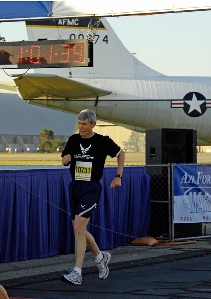 Air Force Chief of Staff Gen. Norton Schwartz crosses the finish line at the  Air Force Marathon on Sept. 18, 2010, at Wright-Patterson Air Force Base, Ohio.  General Schwartz and his wife Suzie joined a record setting crowd of 12,000 runners at the 14th annual event.  General Schwartz finished the 10k run with a time of 1:00:23. (U.S. Air Force photo by Mike Libecap)

