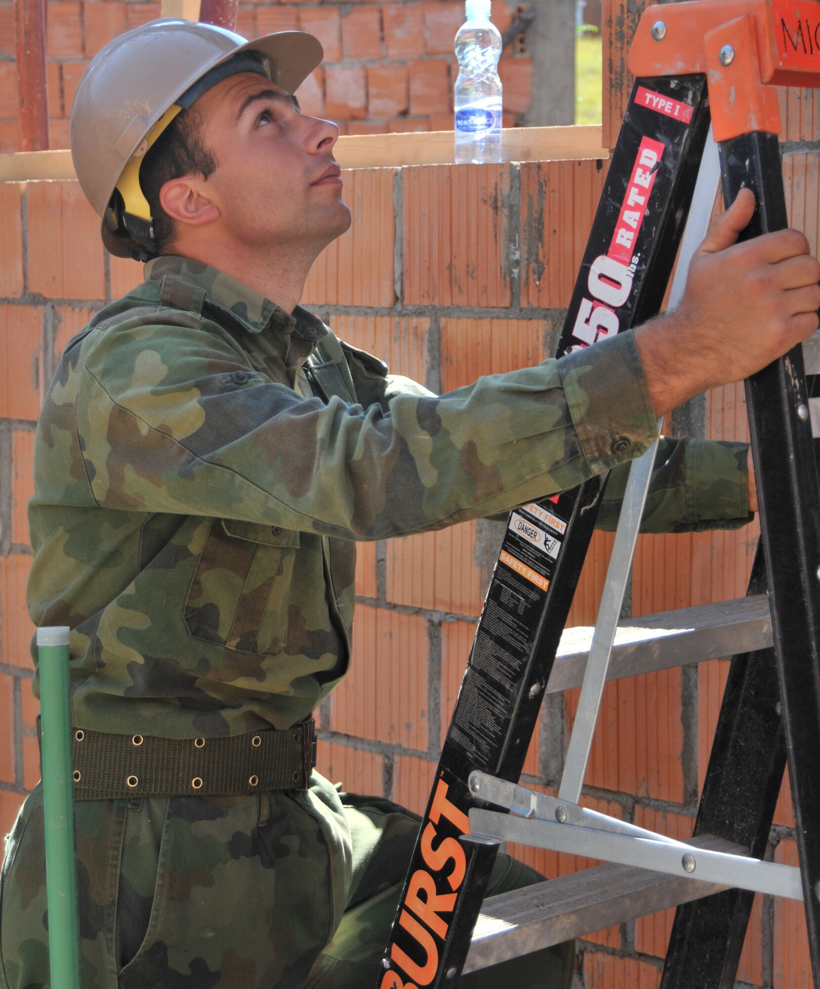 Montenegrin soldier Dalebor Drljevic steadies a ladder for a U.S. Navy Seabee during construction of an urgent care facility in Kolasin, Montenegro, Sept. 16. The clinic, funded by U.S. European Command as part of the 2010 Medical Training Exercise in Central and Eastern Europe, will provide vital capacity in Montenegro’s medical service. For more information, go to www.usafe.af.mil/medceur.asp and www.odbrana.gov.me. (U.S. Air Force photo/Senior Airman David Dobrydney)