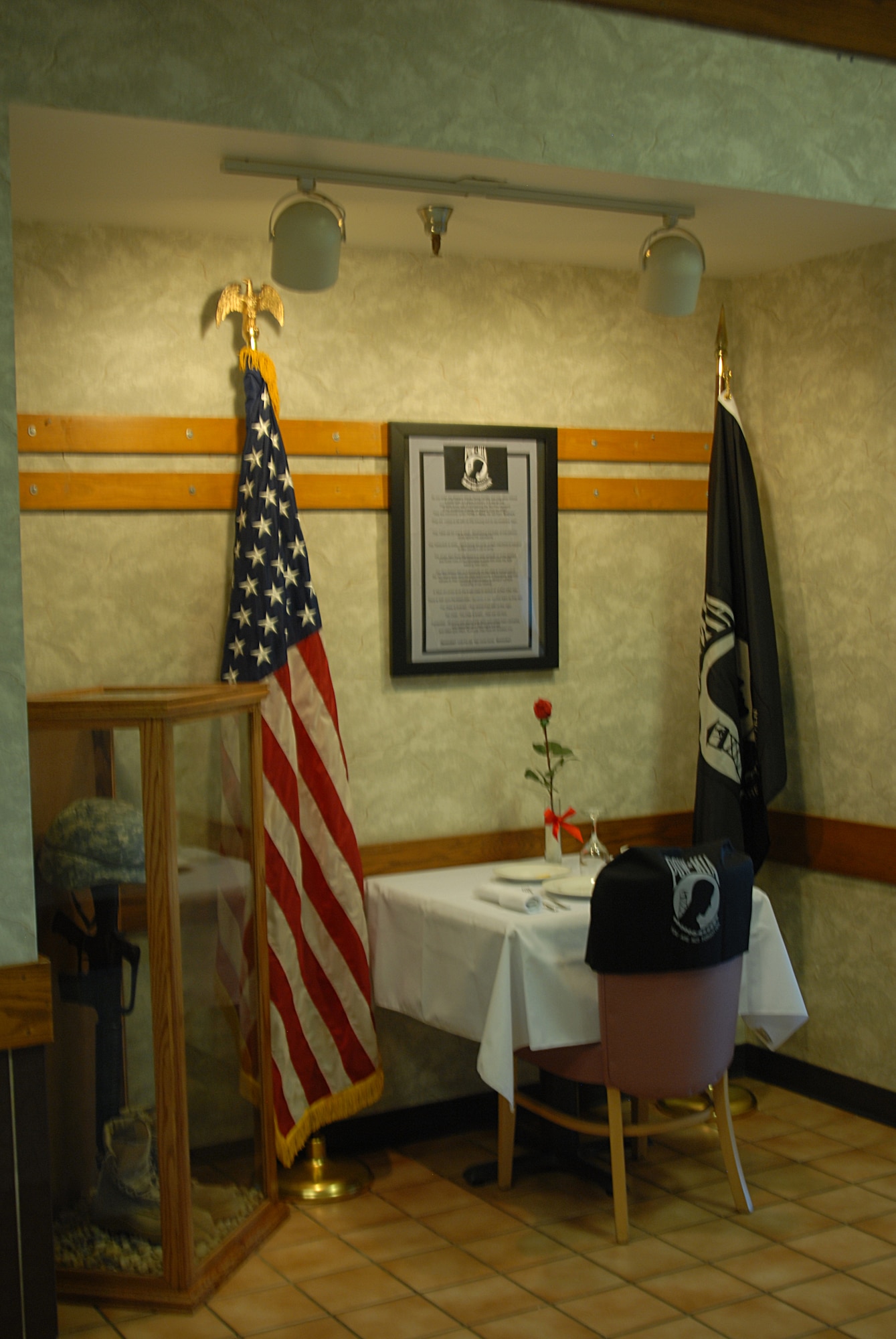 GOODFELLOW AIR FORCE BASE, Texas -- Western Winds Dining Facility erected this memorial in honor of Prisoner of War/Missing in Action Day, Sept.17. David Minard, the Food Services Officer, Richard Chin, Food Quality Assurance and Pragedes Valdez, Facility Manager helped to design and erect the memorial, which is cleary visible upon entering the main door to the facility. ( U.S. Air Force photo/Airman 1st Class Jessica D. Keith)
