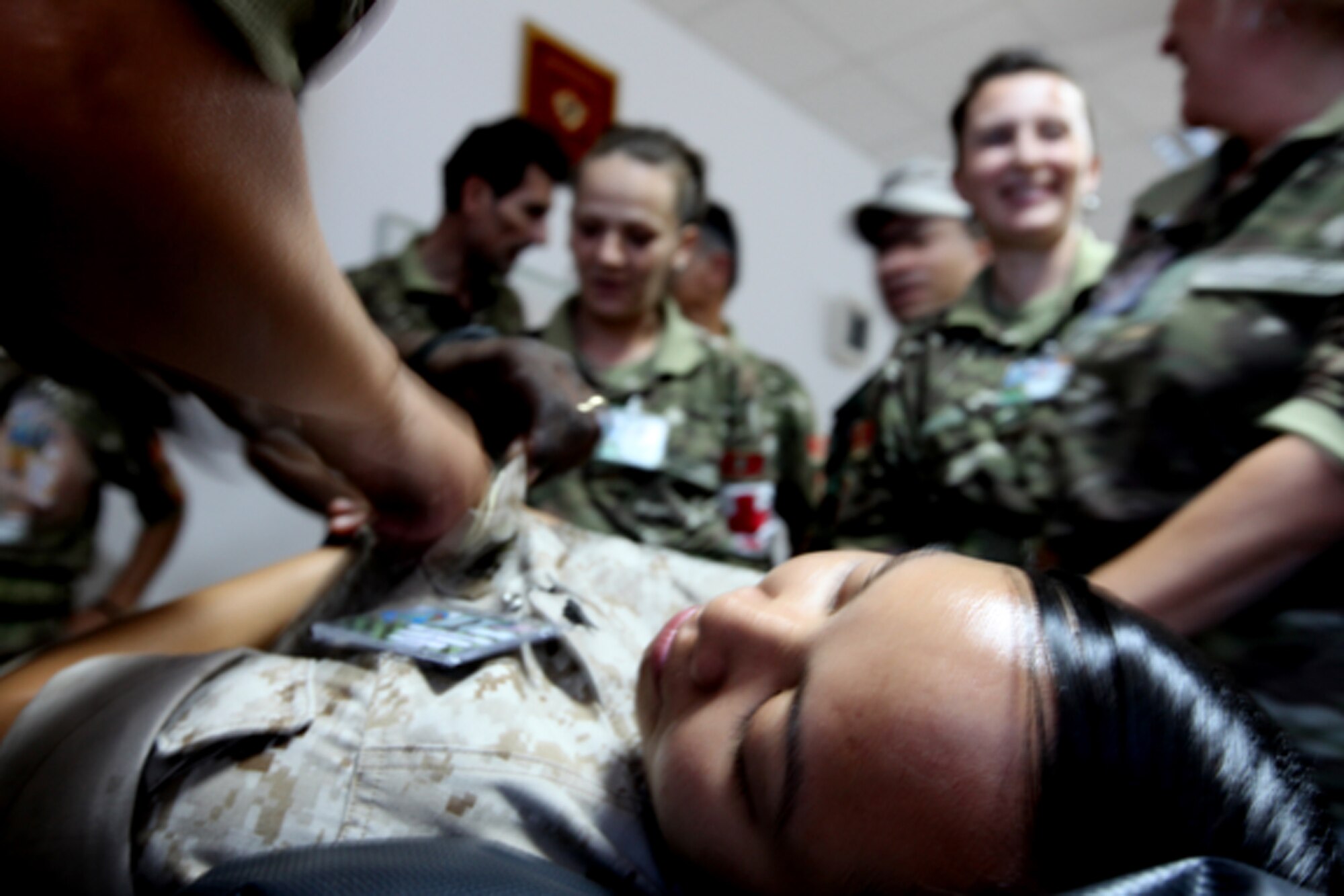 Cpl. Whelma Villaester, a Personnel Retrieval and Processing specialist with Detachment PRP, Smyrna, Ga., plays dead as foreign forces practice body searches as part of Medical Training Exercise in Central and Eastern Europe 2010 at Danilovgrad Army Base, Montenegro. MEDCEUR 10 is an annual U.S. Joint Chiefs of Staff-sponsored exercise meant to improve mass casualty disaster response and increase interoperability between the U.S. and participating nations. For more information, go to www.usafe.af.mil/medceur.asp and www.odbrana.gov.me. (U.S. Marine Corps photo/Lance Cpl. Jad Sleiman)