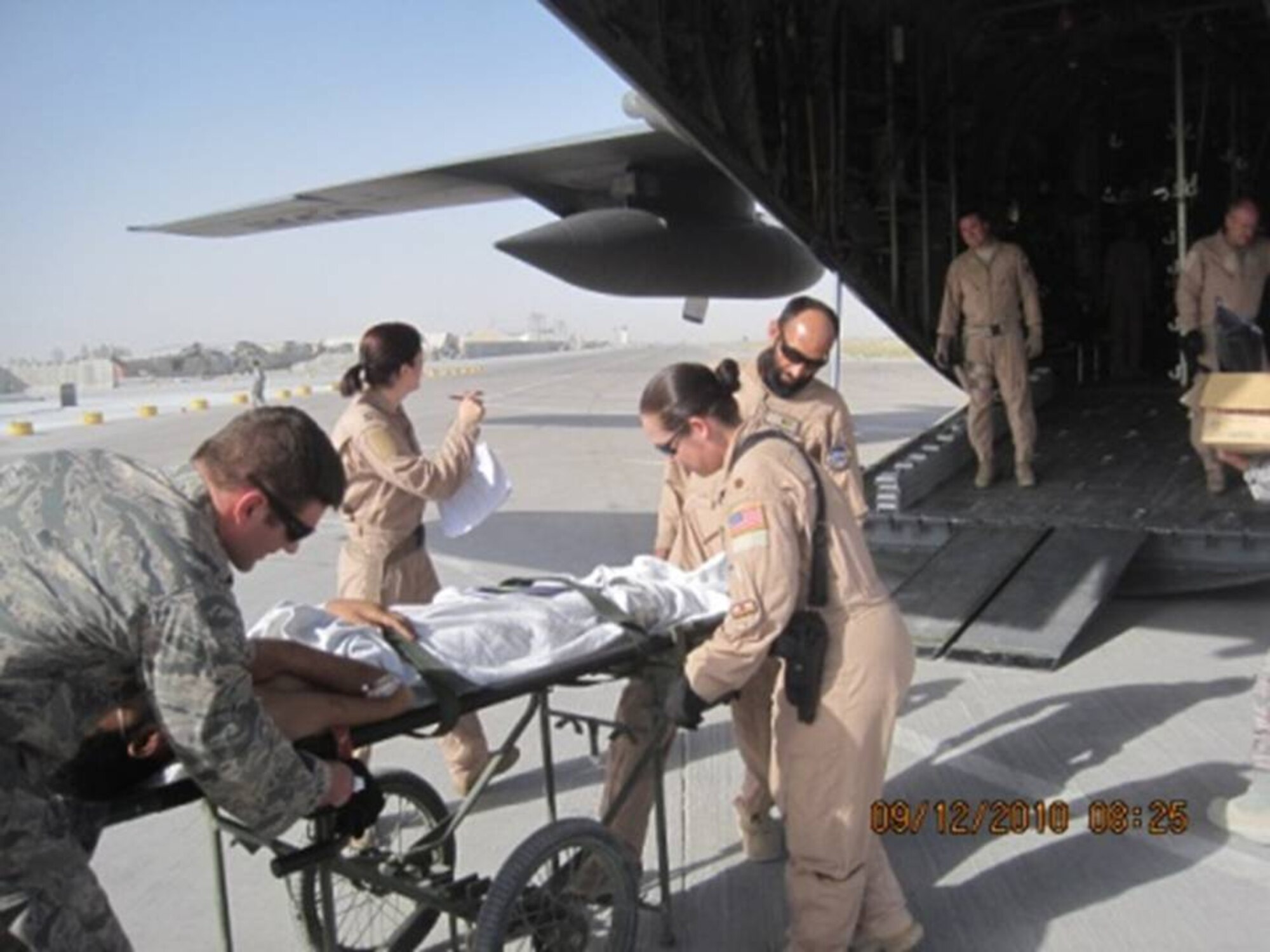 KANDAHAR, Afghanistan - Afghan and U.S. Air Force Flight Medics ready a litter patient for upload to the C-130 on Sept 12, 2010. (U.S. Military photo/RELEASED).