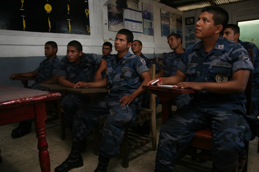 A student body consisting of one junior Nicaraguan lieutenant, a Nicaraguan Navy petty officer and six soon-to-be Nicaraguan Marine Corps corporals listen attentively as Marines give them a class on leadership principles at Naval Base El Bluff, near Bluefields, Nicaragua Sept. 19. Seven Marine non-commissioned officers and one staff NCO participated in a subject-matter expert exchange to give a leadership fundamentals course to eight members of the Nicaraguan Navy and Marine Corps.