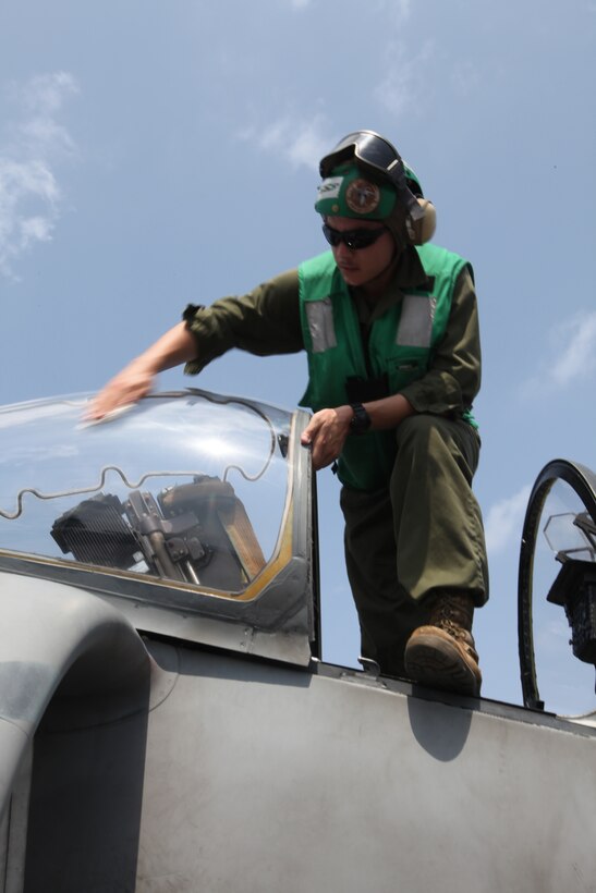 Lance Cpl. Abraham Colton, seat shop technician with Marine Medium Tiltrotor Squadron 266 (Reinforced), 26th Marine Expeditionary Unit, cleans the windshield of an AV-8B Harrier on the flight deck aboard USS Kearsarge in the Red Sea, Sept. 19, 2010. 26th Marine Expeditionary Unit deployed aboard the ships of Kearsarge Amphibious Ready Group in late August responding to an order by the Secretary of Defense to support Pakistan flood relief efforts.