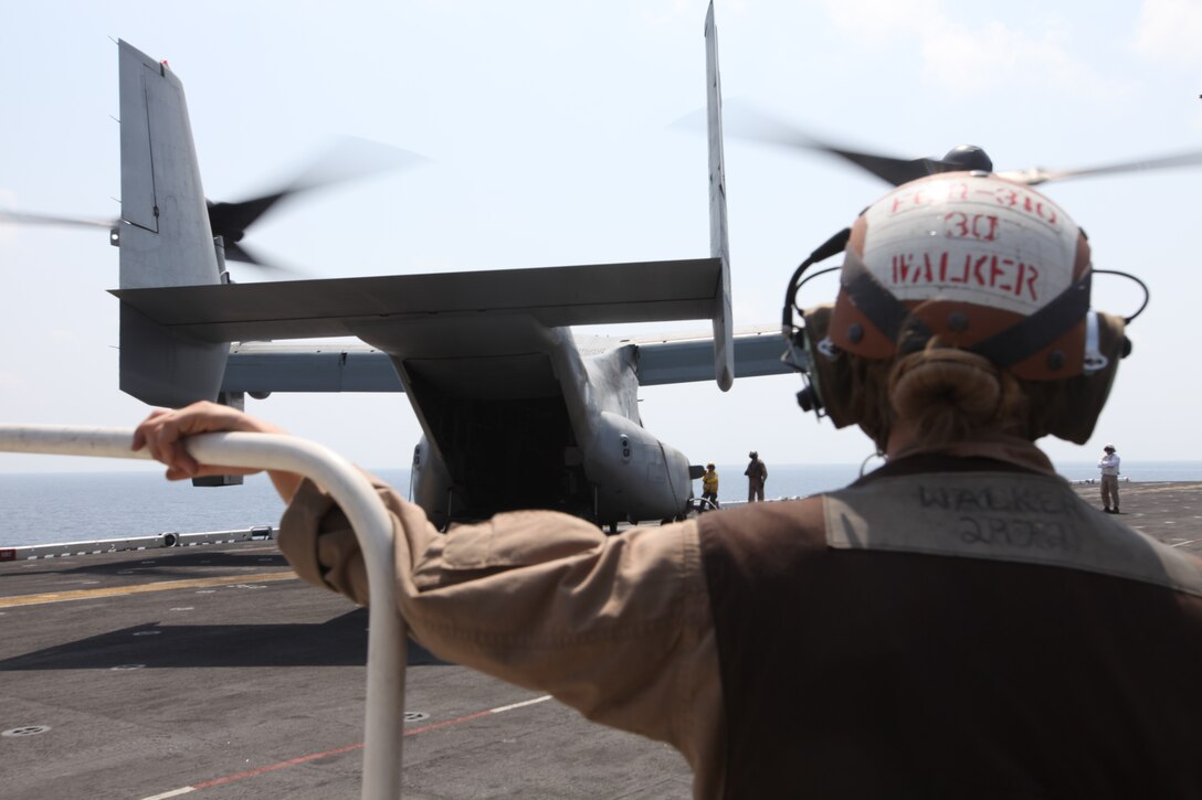 Corporal Kathleen Walker, MV-22 Osprey crew chief with Marine Medium Tiltrotor Squadron 266 (Reinforced), 26th Marine Expeditionary Unit, stands by to board an MV-22 Osprey on the flight deck aboard USS Kearsarge in the Red Sea, Sept. 19, 2010. 26th Marine Expeditionary Unit deployed aboard the ships of Kearsarge Amphibious Ready Group in late August responding to an order by the Secretary of Defense to support Pakistan flood relief efforts.