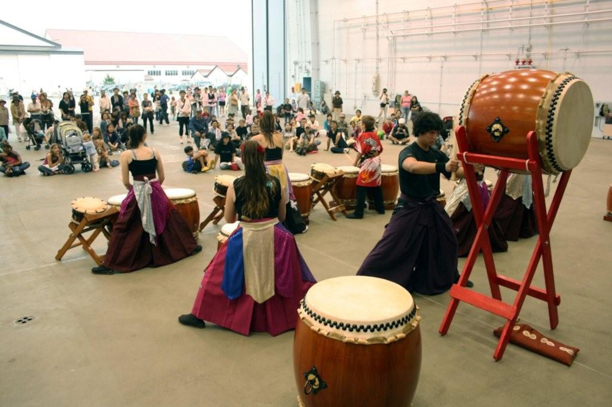 Matthew Bernal, a junior at Edgren High School, here, beats on the lead drum as fellow team members play for the air show crowd at Misawa Air Base, Japan, Sept. 19, 2010. Bernal is the team captain for the Dragon-Eagle Taiko Team, the only American Team of Taiko players in Japan. (U.S. Air Force photo/Capt. Darrick B. Lee/Released)