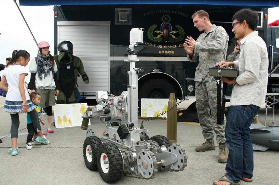 U.S. Air Force Senior Airman Matthew Thompson,  35th Civil Engineer Squadron, demonstrates the capabilities of the unit's bomb disposal robot to  attendees at the 2010 Misawa Air Base, Japan Air Festival, Sept. 19, 2010. Aside from aerial performances, numerous static displays allowed visitors to learn more about U.S. combat capabilities. (U.S. Air Force photo by Capt. Darrick B. Lee/Released)