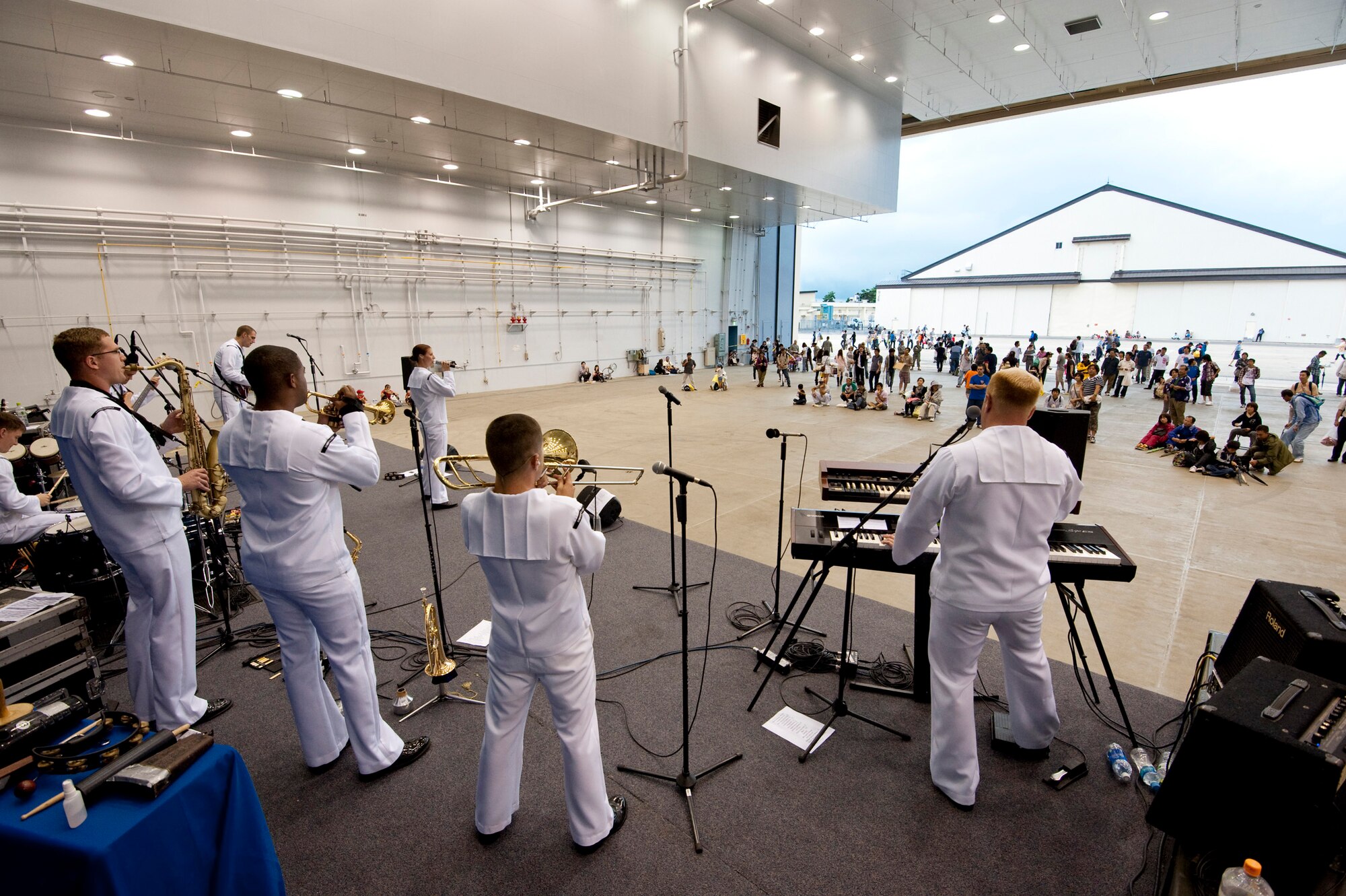 The U.S. Navy 7th Fleet Band "Orient Express" plays for a Japanese audience during a feature performance in Hangar 963 during Misawa Air Festival 2010 at Misawa Air Base, Japan, Sept. 19, 2010. The band visited Misawa from Yokosuka, Japan. (U.S. Air Force photo by Staff Sgt. Samuel Morse/Released)