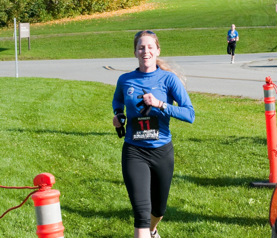 KULIS AIR NATIONAL GUARD BASE, Alaska -- Capt. Jennifer Haney, a pilot with the 144th Airlift Squadron, crosses the finish line during the first-ever 176th Wing Duathlon, held here Sept. 18, 2010. The Kulis Senior Enlisted Association sponsored the event. AKANG photo by 1st. Lt. John Callahan.