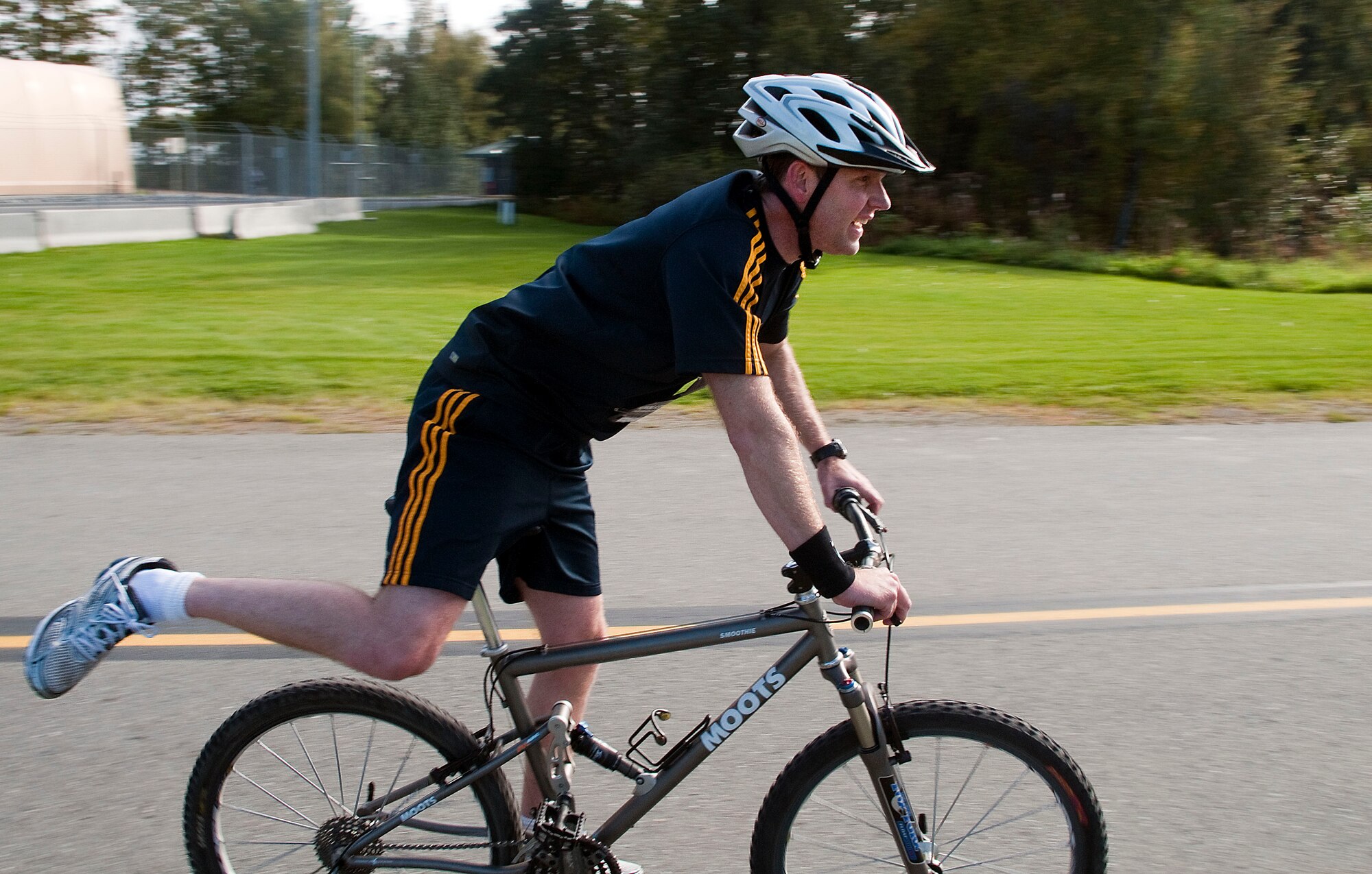 KULIS AIR NATIONAL GUARD BASE, Alaska -- A competitor prepares to dismount in preparation for the final stretch of the first-ever 176th Wing Duathlon, held here Sept. 18, 2010. The Kulis Senior Enlisted Association sponsored the event. AKANG photo by 1st. Lt. John Callahan.