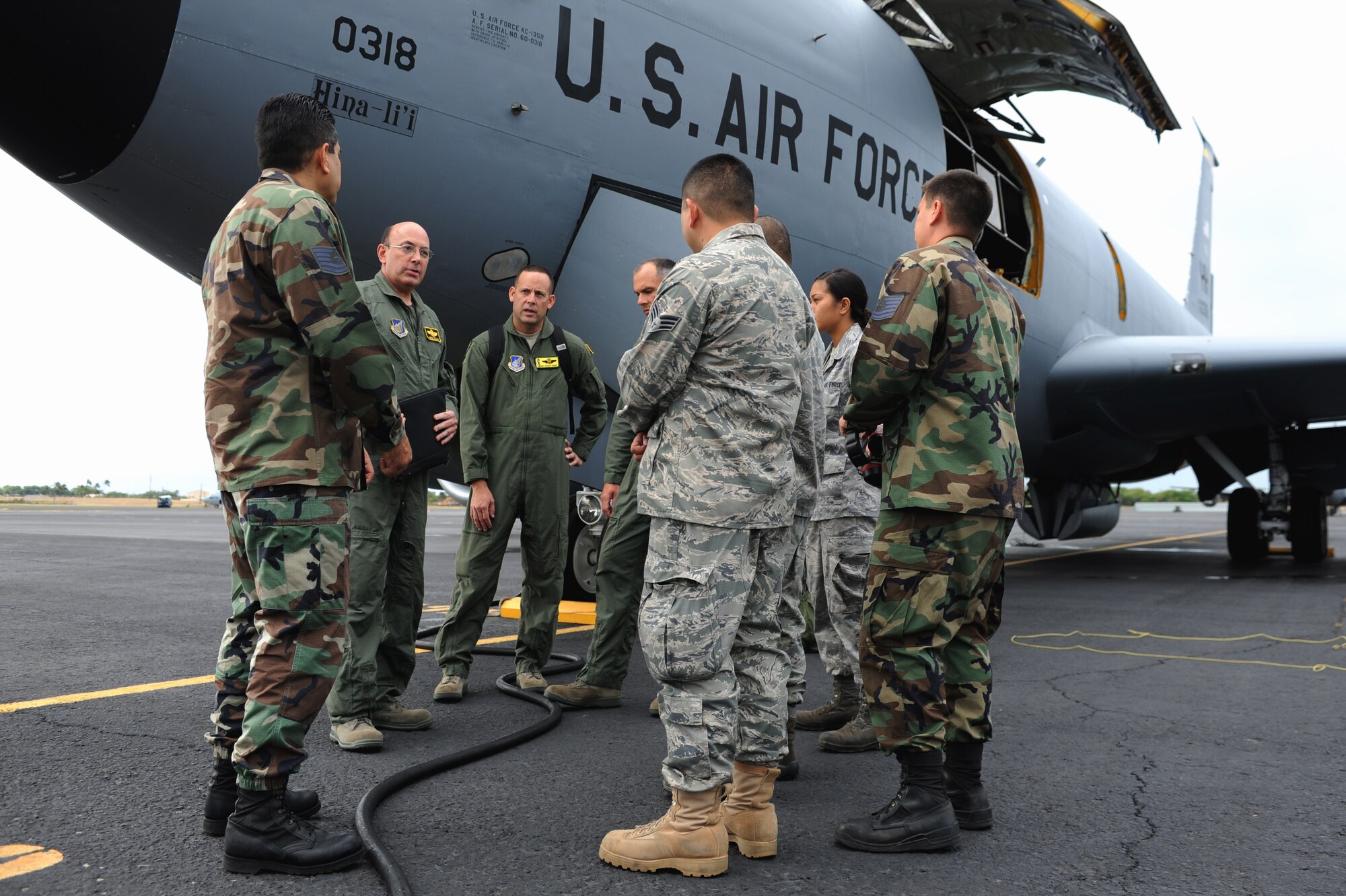 JOINT BASE PEARL HARBOR HICKAM, Hawaii -- Lt. Col. Gene Feller, 203rd Air Refueling Squadron pilot, Maj. Jeff Paget and Senior Master Sgt. Dicky Hunt, 96th Air Refueling Squadron, go over maintenance record during a pre-flight inspection with members of the maintenance crew prior to a refueling mission Sept. 18. They performed a refueling mission with a C-17 Globemaster III bound for Andersen Air Base, Guam. The C-17 assigned to the 15th Wing, Joint Base Pearl Harbor Hickam, is operated by the 15th Wing and the Hawaii National Guard?s 154th Wing. Through a Total Force Integration partnership, the Activity Duty and Guard units jointly operate the C-17, the KC-135 Stratotanker and the F-22 Raptor. (U.S. Air Force photo/Staff Sgt. Mike Meares)