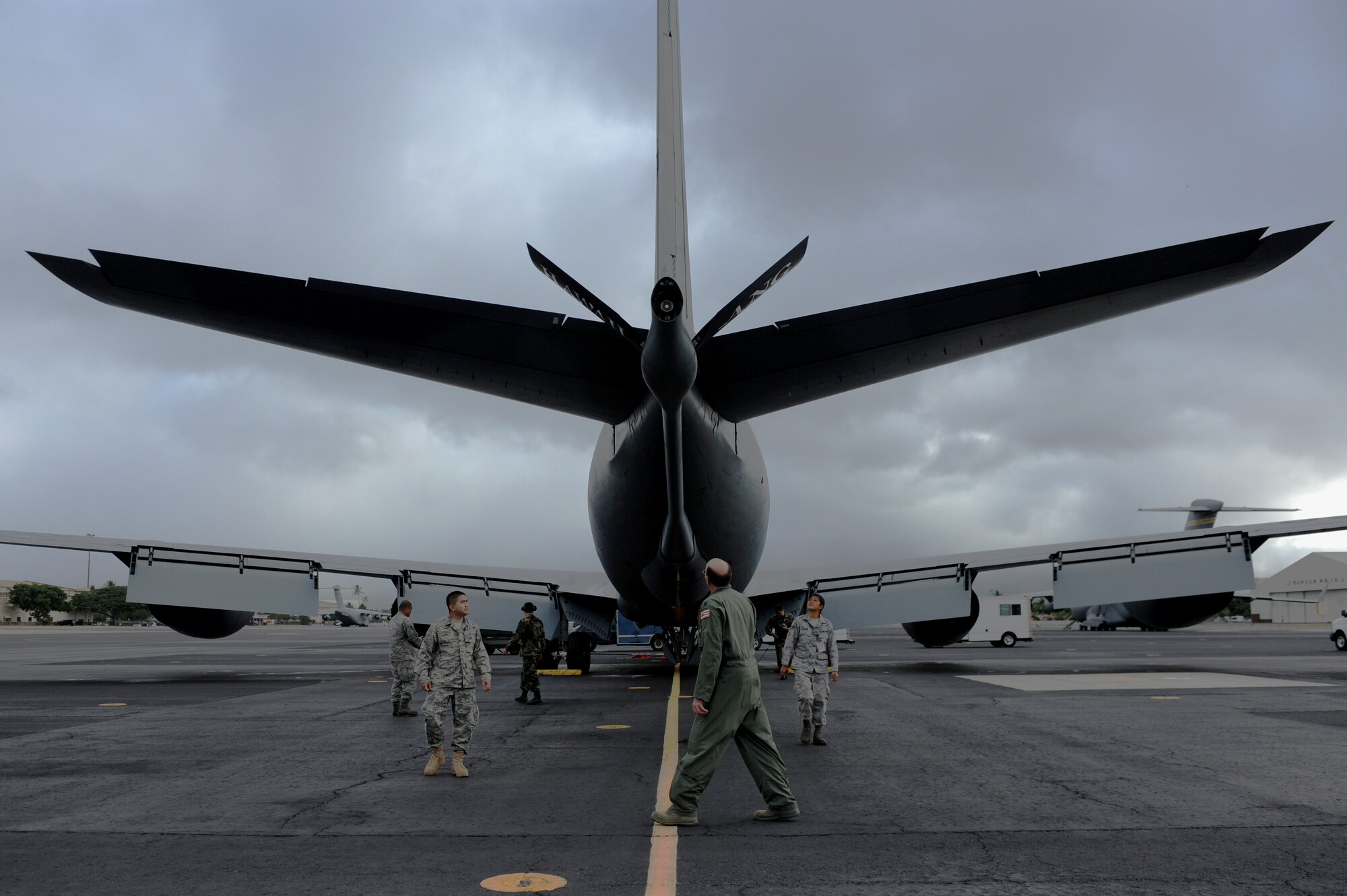 JOINT BASE PEARL HARBOR HICKAM, Hawaii -- Lt. Col. Gene Feller, 203rd Air Refueling Squadron pilot, goes through a pre-flight inspection with members of the maintenance crew prior to a refueling mission Sept. 18. They performed a refueling mission with a C-17 Globemaster III bound for Andersen Air Base, Guam. The C-17 assigned to the 15th Wing, Joint Base Pearl Harbor Hickam, is operated by the 15th Wing and the Hawaii National Guard?s 154th Wing. Through a Total Force Integration partnership, the Activity Duty and Guard units jointly operate the C-17, the KC-135 Stratotanker and the F-22 Raptor. (U.S. Air Force photo/Staff Sgt. Mike Meares)