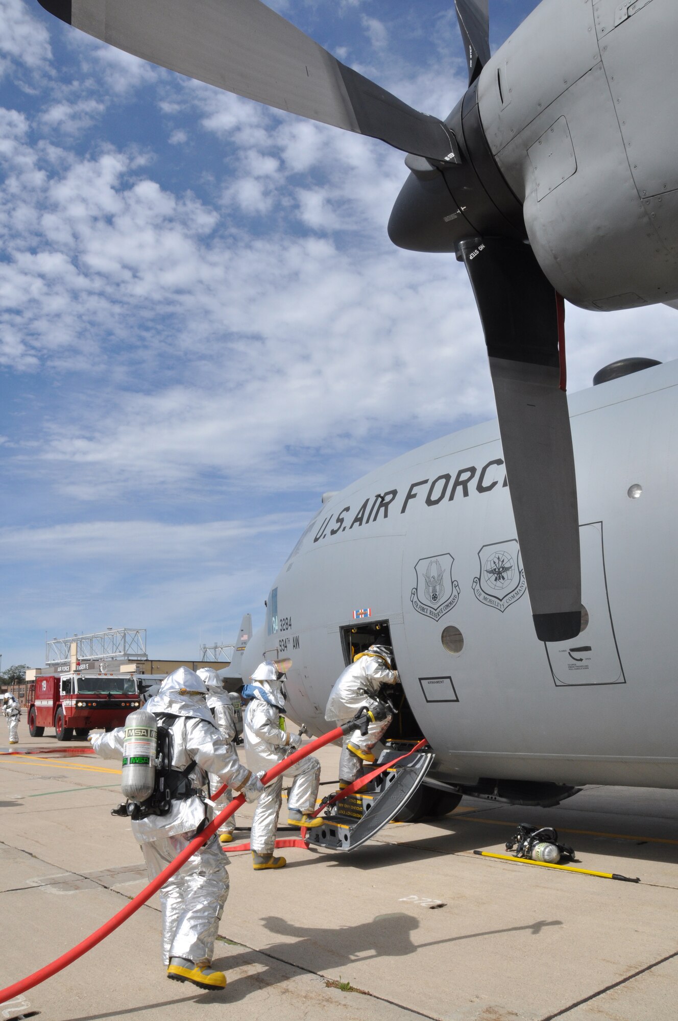 Fire fighters from the 934th Civil Engineer Squadron enter a C-130 during an aircraft emergency exercise here, September 18.  The exercise was part of the base-wide Unit Compliance Inspection to prepare members for real-world emergencies. (U.S. Air Force photo/Senior Airman Noah R. Johnson)