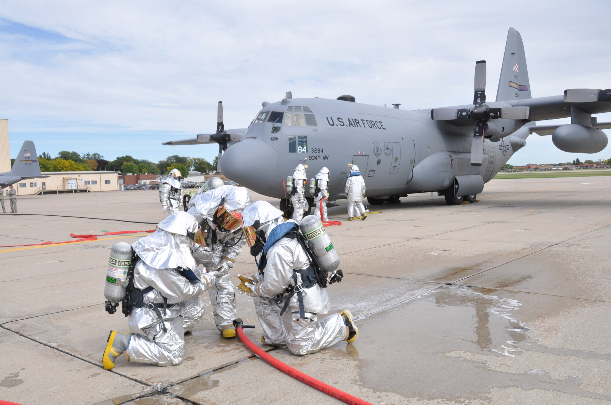 Fire fighters from the 934th Civil Engineer Squadron prepare to enter a C-130 during an aircraft emergency exercise here, September 18.  The exercise was part of the base-wide Unit Compliance Inspection to prepare members for real-world emergencies. (U.S. Air Force photo/Senior Airman Noah R. Johnson)