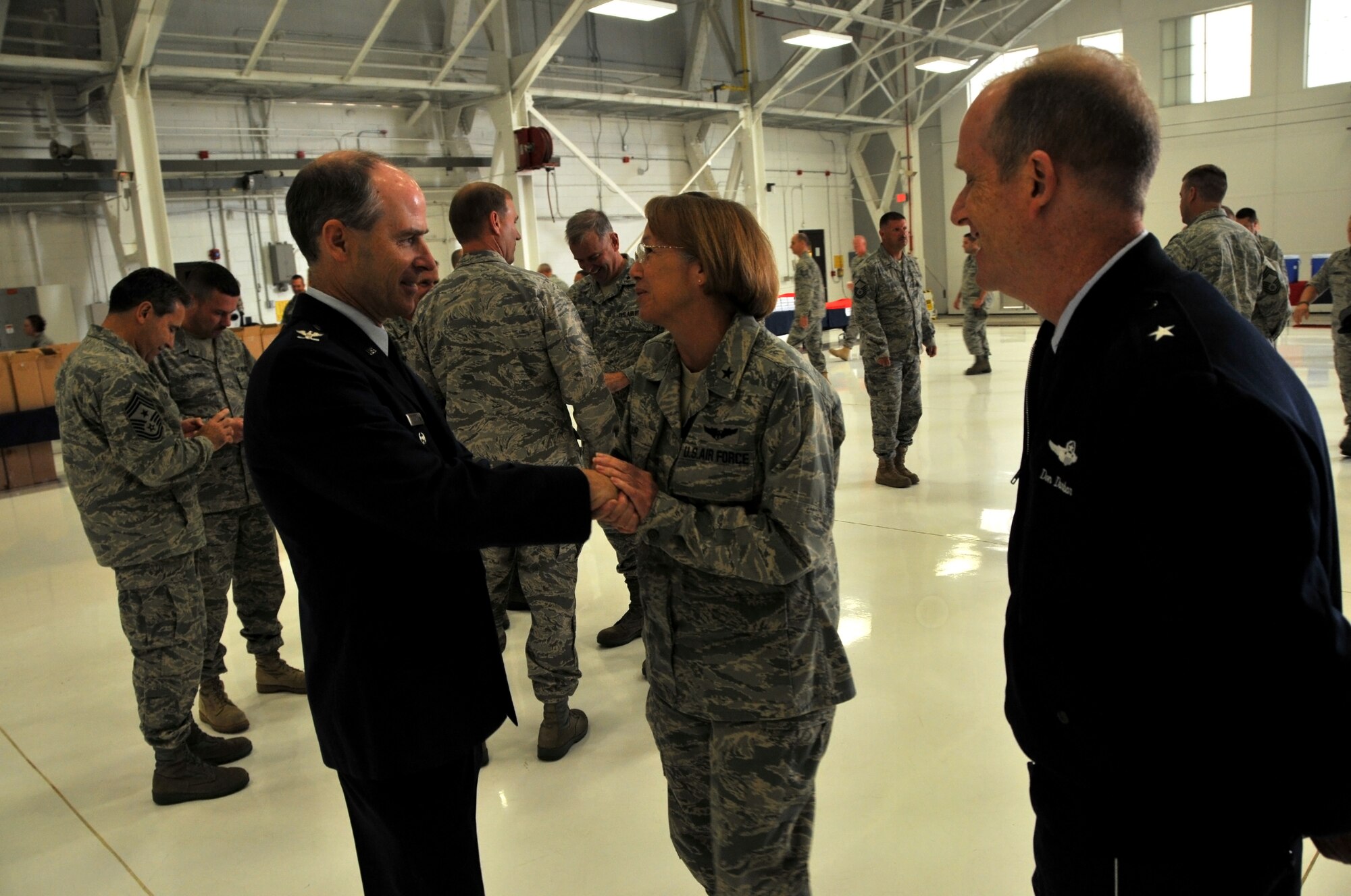 Colonel Michael Hinman accepts congratulations from Brig. Generals Margaret Bair, chief of staff for the Wisconsin Air National Guard, and Donald Dunbar, Wisconsin National Guard adjutant general on a 34 year military career.  As a member of the 115th Fighter Wing, Colonel Hinman served most recently as the vice commander of the wing in Madison. In June, Colonel Hinman was appointed by Governor Jim Doyle as the administrator of Wisconsin Emergency Management. (U.S. Air Force photo by Tech. Sgt. Don Nelson)