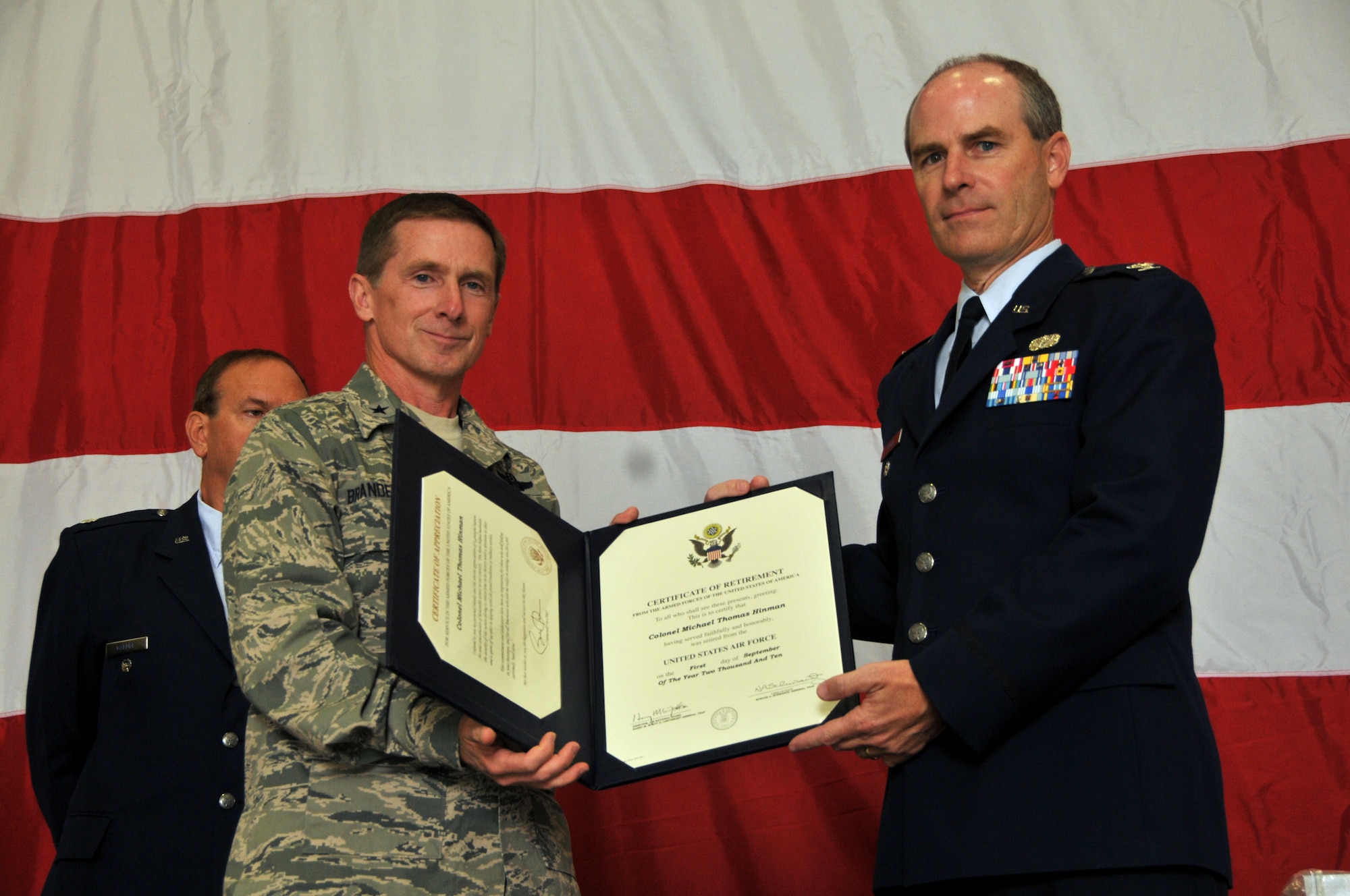 Brigadier General Joseph Brandemuehl, 115th Fighter Wing commander, presents Colonel Michael Hinman his certificate of retirement as he completes a 34 year military career.  As a member of the 115th Fighter Wing, Colonel Hinman served most recently as the vice commander of the wing in Madison. In June, Colonel Hinman was appointed by Governor Jim Doyle as the administrator of Wisconsin Emergency Management. (U.S. Air Force photo by Tech. Sgt. Don Nelson)
