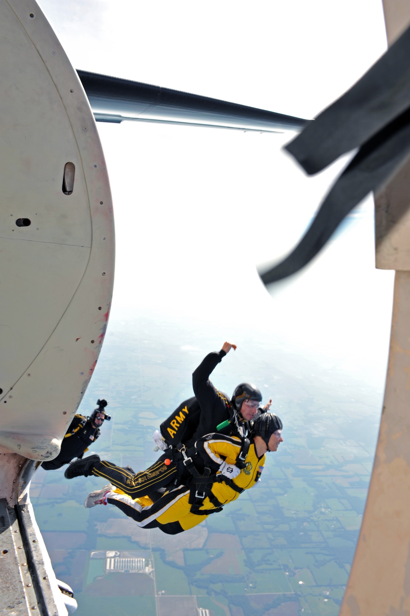 WHITEMAN AFB, MO - Katie Horner, KCTV5 chief meteorologist (yellow suit), jumps tandem with the U.S. Army Golden Knights demonstration team, Sept. 18. Mrs. Horner joined KCTV5 in 1994 and was recently named “Most Influential Woman” in 2010 by KC Business Magazine. (U.S. Air Force photo/ Tech. Sgt. Charles Larkin Sr.)