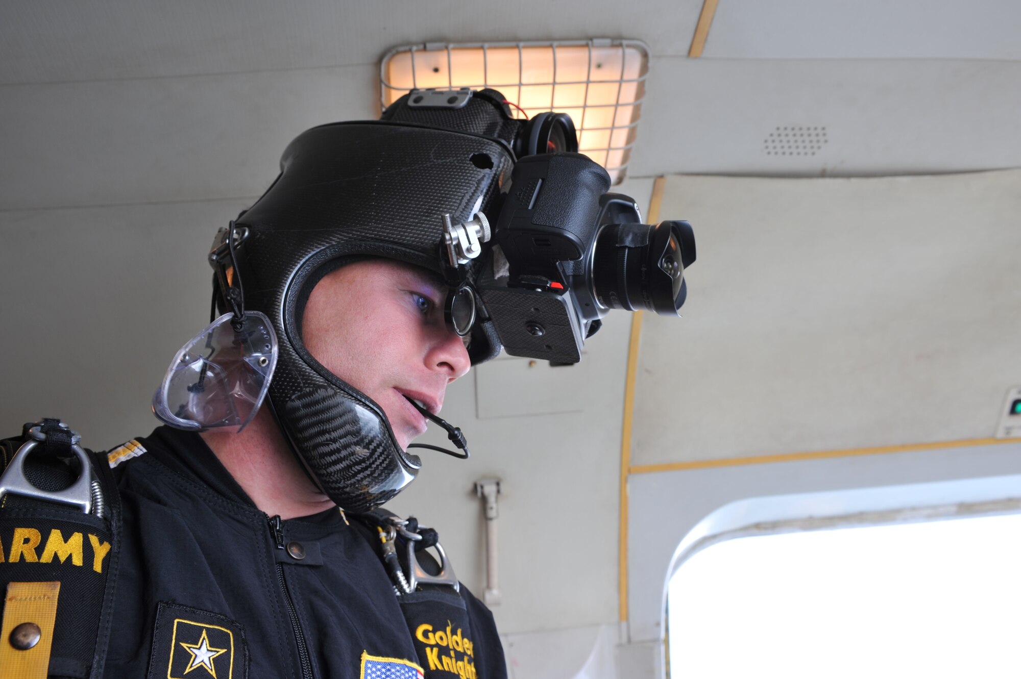 WHITEMAN AFB, MO - Staff Sgt. Joe Aben, U.S. Army Golden Knights demonstration team parachutist, gears up for the initial demonstration jump, Sept. 18. Sergeant Aben documented the jump using a carbon-fiber helmet fitted with still and motion cameras. (U.S. Air Force photo/ Tech. Sgt. Charles Larkin Sr.)