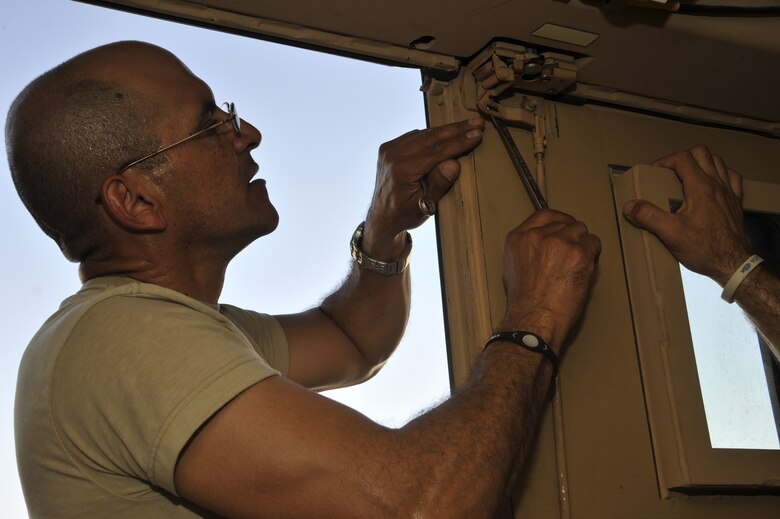 Sgt. Feliz Rodriguez, Redistribution Property Assistance team maintenance technician, removes a broken latch from a Mine Resistant Ambush Protected vehicle Sept. 12, 2010, at Al Asad Air Base, Iraq. RPAT inspects and loads military equipment to be sent back to the U.S, Afghanistan or given to Iraqi Security forces.(U.S. Air Force photo by Senior Airman Perry Aston) (Released)