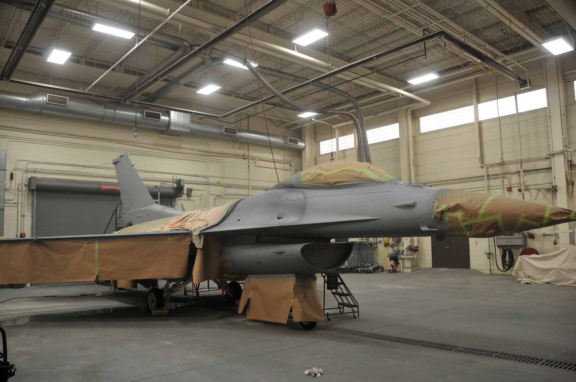A Madison based F-16 stands ready to be painted on Sept. 18, 2010 at Truax Field.  The aircraft, which was acquired from the Ohio Air National Guard, is receiving its initial painting in the 115th colors. (Air National Guard photo by Staff Sergeant Stephen Montgomery)

