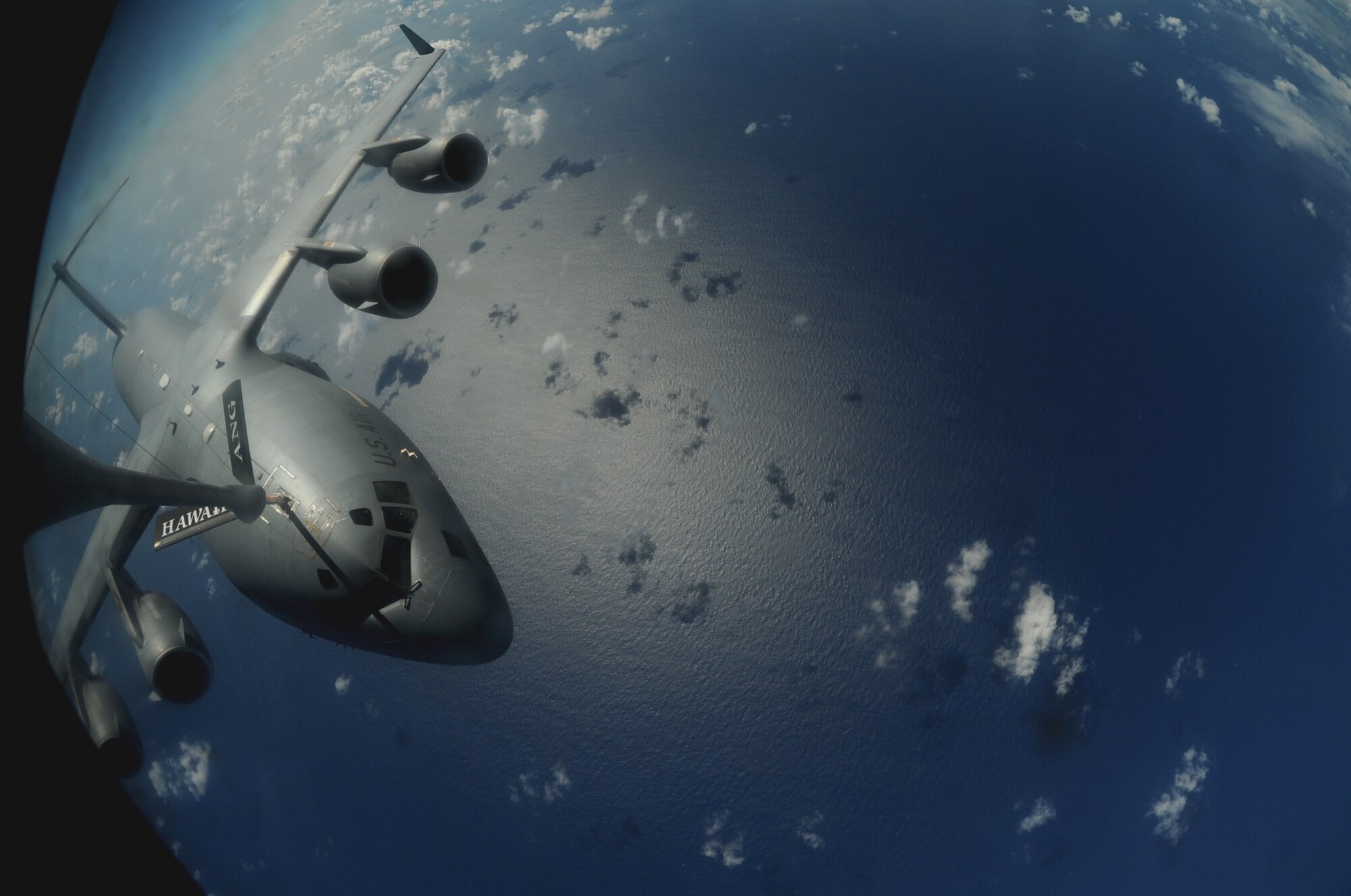 OVER THE PACIFIC -- A C-17 Globemaster III from the 15th Wing, Joint Base Pearl Harbor Hickam, takes on fuel from a Hawaii Air National Guard 204th Air Refueling Squadron KC-135 Stratotanker during a mission to Andersen Air Base, Guam.  The 15th Wing and the Hawaii National Guard?s 154th Wing operate both the C-17 and the KC-135 in a Total Force Integration partnership. They also operate the F-22 Raptor. (U.S. air Force photo/Staff Sgt. Mike Meares)