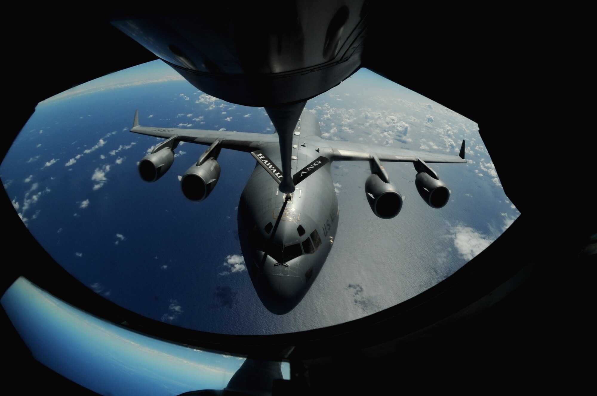 OVER THE PACIFIC -- A C-17 Globemaster III from the 15th Wing, Joint Base Pearl Harbor Hickam, takes on fuel from a Hawaii Air National Guard 204th Air Refueling Squadron KC-135 Stratotanker during a mission to Andersen Air Base, Guam.  The 15th Wing and the Hawaii National Guard?s 154th Wing operate both the C-17 and the KC-135 in a Total Force Integration partnership. They also operate the F-22 Raptor. (U.S. air Force photo/Staff Sgt. Mike Meares)