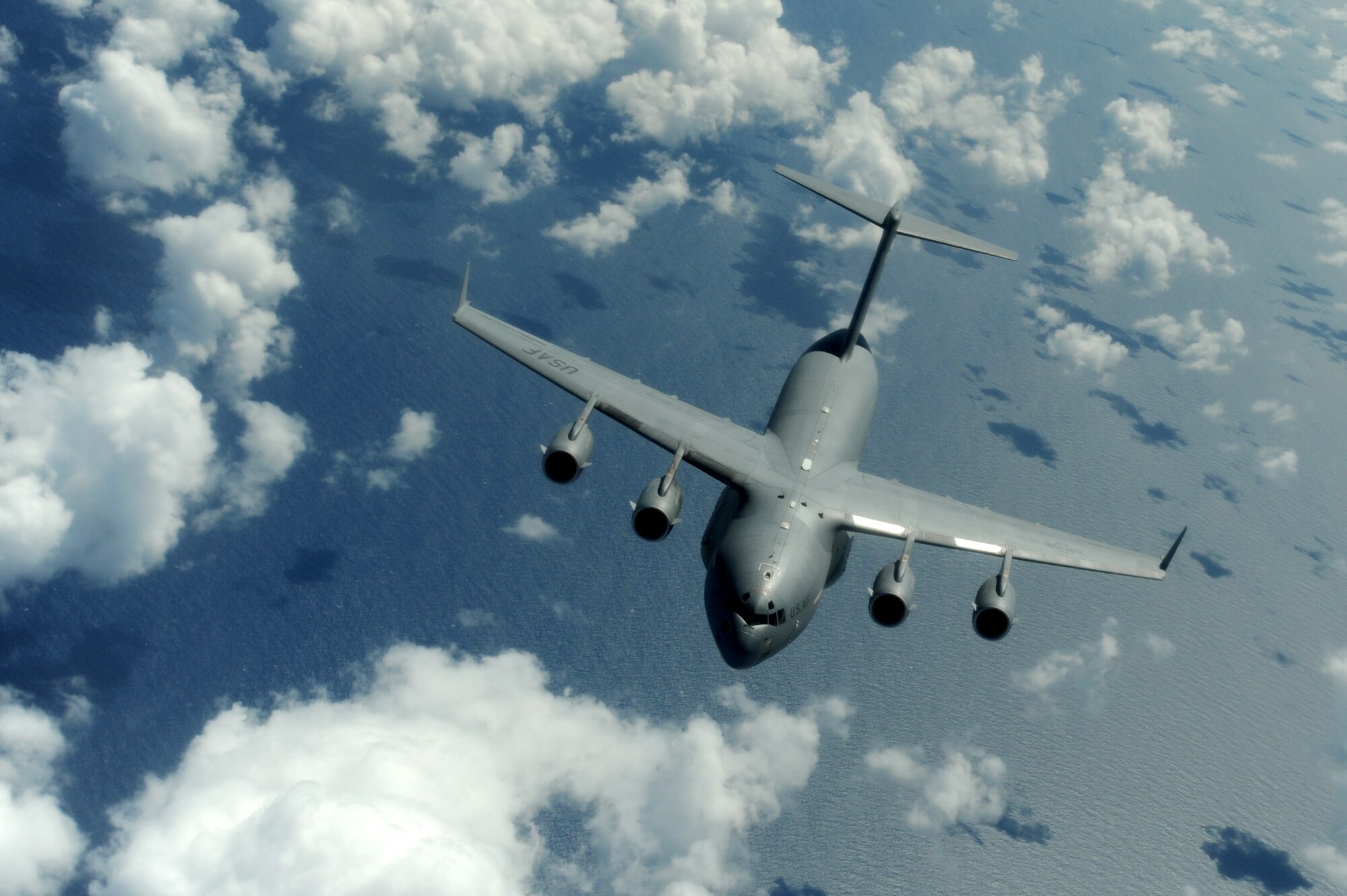 OVER THE PACIFIC -- A C-17 Globemaster III from the 15th Wing, Joint Base Pearl Harbor Hickam, takes on fuel from a Hawaii Air National Guard 204th Air Refueling Squadron KC-135 Stratotanker during a mission to Andersen Air Base, Guam.  The 15th Wing and the Hawaii National Guard?s 154th Wing operate both the C-17 and the KC-135 in a Total Force Integration partnership. They also operate the F-22 Raptor. (U.S. air Force photo/Staff Sgt. Mike Meares)