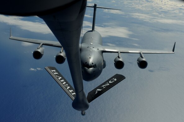 OVER THE PACIFIC -- A C-17 Globemaster III from the 15th Wing, Joint Base Pearl Harbor Hickam, takes on fuel from a Hawaii Air National Guard 204th Air Refueling Squadron KC-135 Stratotanker during a mission to Andersen Air Base, Guam. The 15th Wing and the Hawaii National Guard?s 154th Wing operate both the C-17 and the KC-135 in a Total Force Integration partnership. (U.S. air Force photo/Staff Sgt. Mike Meares) 
