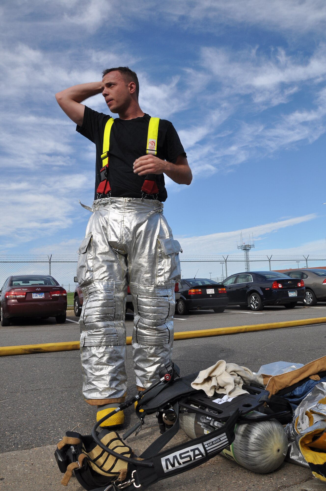 Firefighter...... from 934th Airlift Wing,removes his gear and takes a breath after a building fire exersise here Sept 18, 2010. (Air Force Photo/TSgt Bob Sommer)