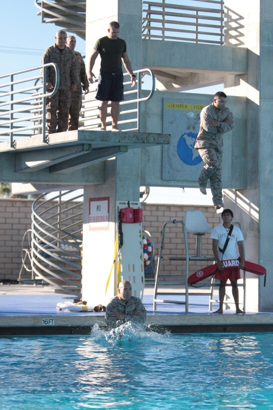 Students with the Combat Logistics Battalion 7-sponsored Corporals Course take part in an abandon ship test during swim qualification at the Combat Center’s Training Tank Monday.