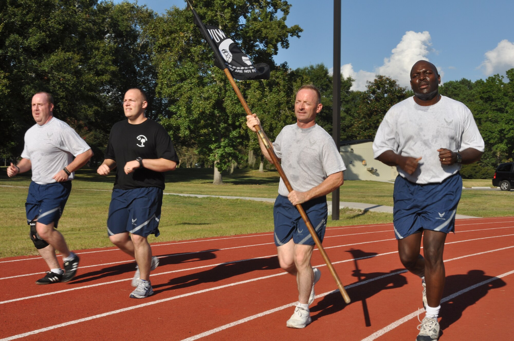 Four members of the 315th Security Forces Squadron proudly carry the flag and run together for 45 minutes during the 4th annual Charleston Air Force Base POW/MIA 24-hour vigil run Sept. 16, 2010 at the base running track. (U.S. Air Force Photo/Staff Sgt. Shane Ellis)