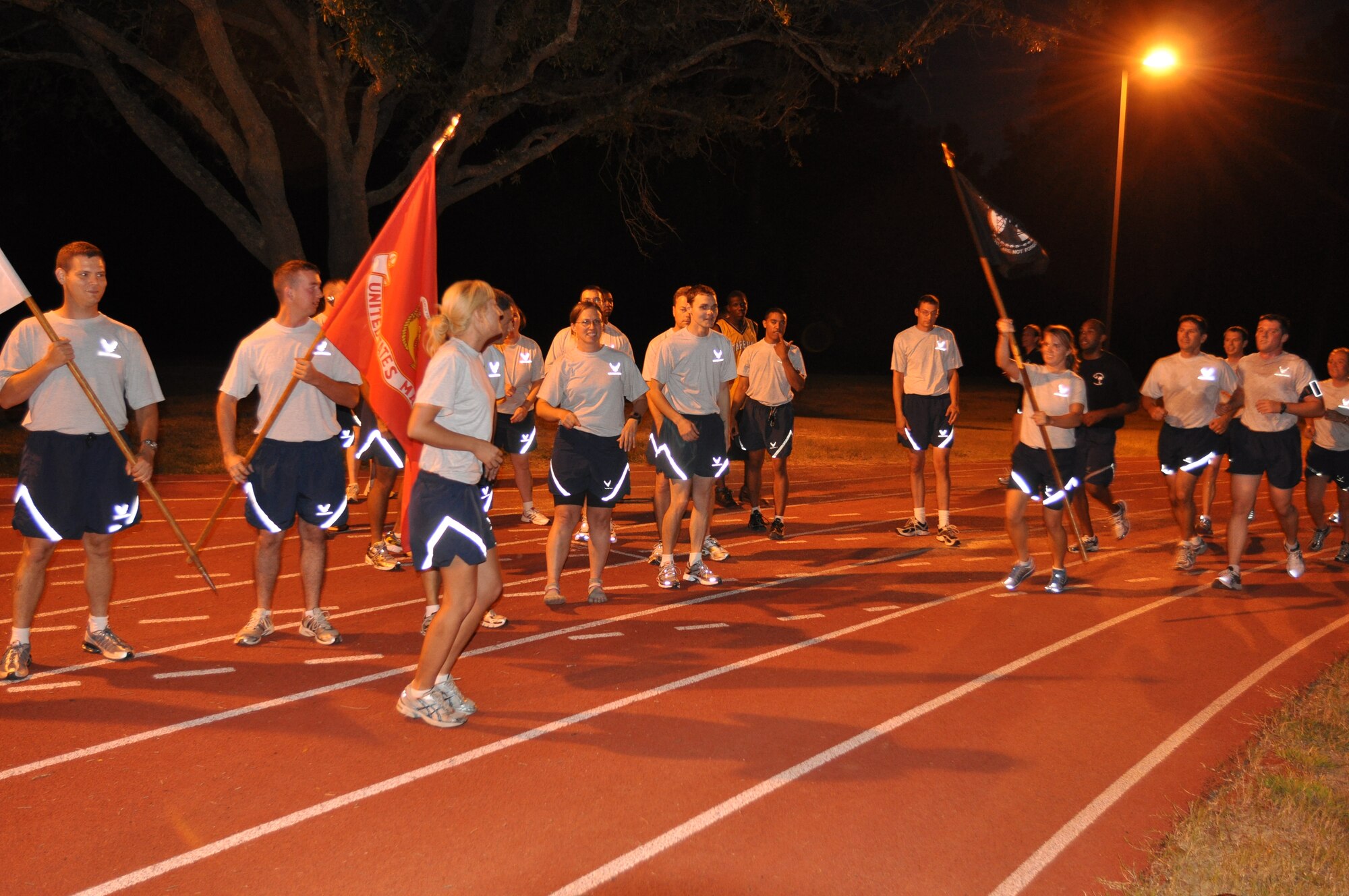 Members of the 315th Aircraft Maintenance Squadron prepare to take the POW/MIA flag during the 4th annual Charleston Air Force Base POW/MIA 24-hour vigil run Sept. 16, 2010 at the base running track. (U.S. Air Force Photo/Staff Sgt. Shane Ellis)