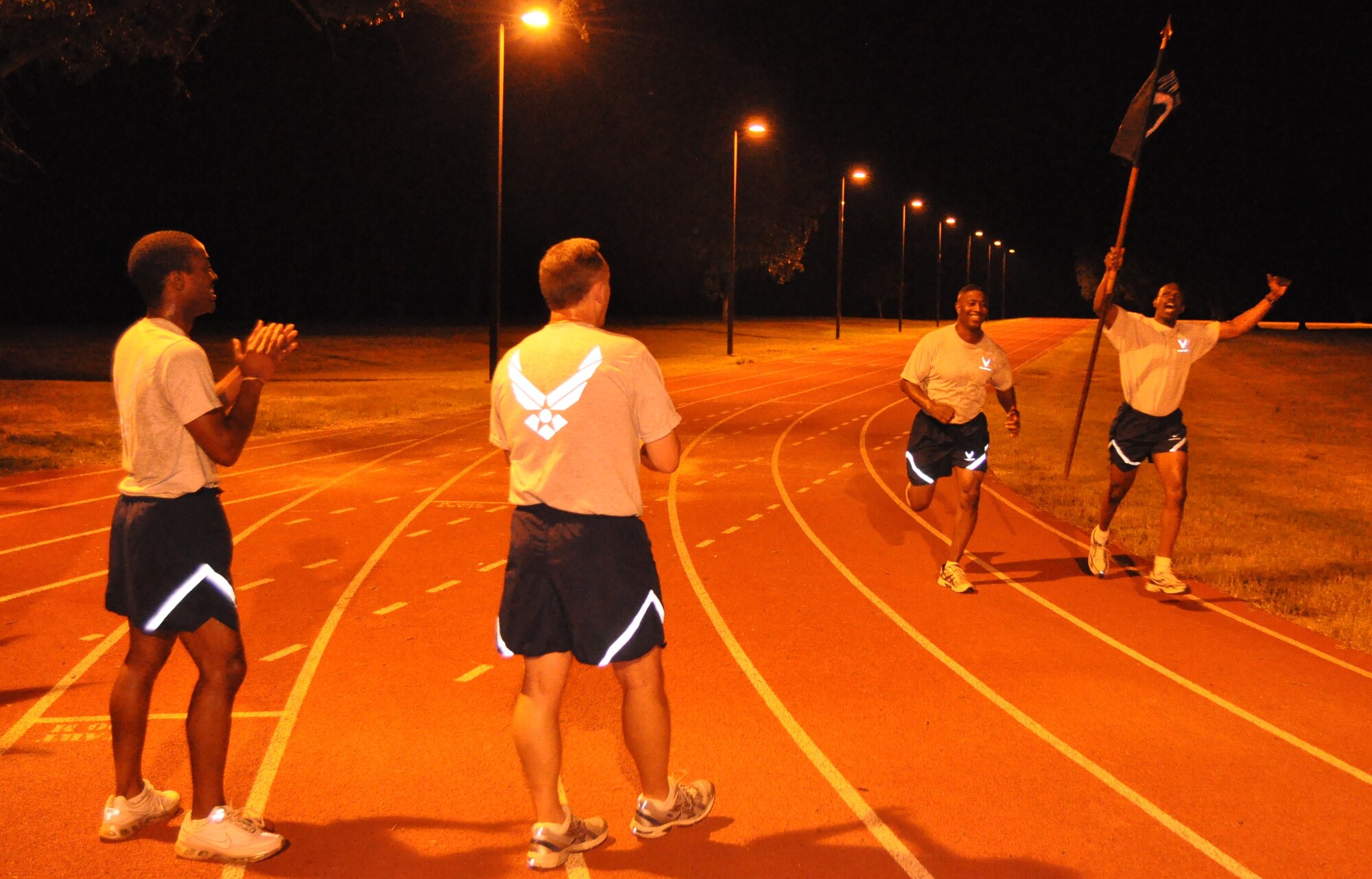 Members of the 315th Aeromedical Evacuation Squadron cheer each other on during the 4th annual Charleston Air Force Base POW/MIA 24-hour vigil run Sept. 16, 2010 at the base running track. (U.S. Air Force Photo/Staff Sgt. Shane Ellis)