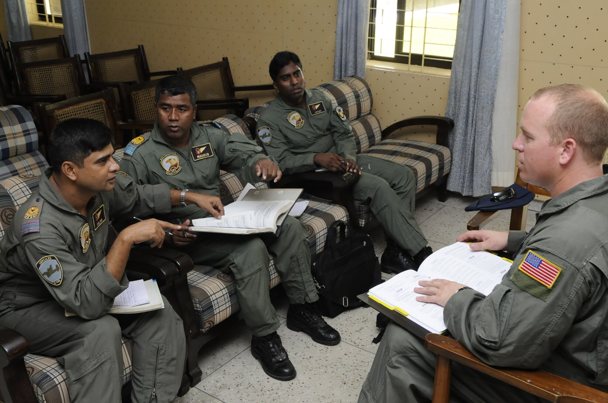 Bangladesh Air Force loadmasters discuss airdrop procedures with Staff Sgt. Jace Hartog, from the 36th Airlift Squadron at Yakota Air Base, Japan, during exercise Cope South 10, on Sept. 20, 2010. The bilateral exercise’s subject-matter expert exchanges in maintenance, operations and rigging disciplines strengthen the strong and growing partnership between the United States and Bangladesh. Two C-130s from Yokota AB and an AN-32 from Kurmitola Air Base are participating in Cope South 10. (U.S.  Air Force photo / Master Sgt. Jeffery Loftin)