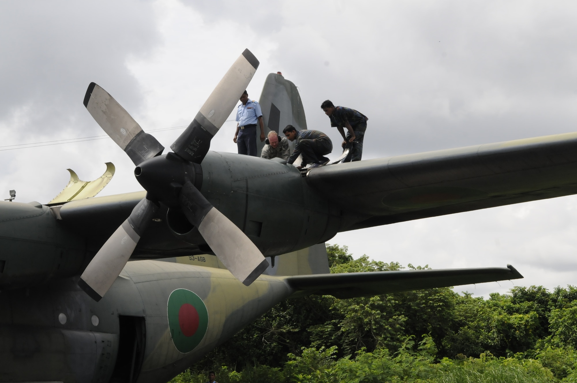 Staff Sgt. Kevin Stubblefield, an aircraft maintainer from the 374th Maintenance Squadron at Yokota Air Base, Japan, helps Sgt. Eakub Ali, Sgt. S.M. Iqbal and Military Warrant Officer Golam Faruque, Bangladesh Air Force aircraft maintainers, troubleshoot an engine problem on a Bangladesh C-130 Herculues during exercise Cope South 10, on Sept. 20, 2010. The bilateral exercise’s subject-matter expert exchanges in maintenance, operations and rigging disciplines strengthen the strong and growing partnership between the United States and Bangladesh. Two C-130s from Yokota Air Base, Japan, and an AN-32 from Kurmitola Air Base are participating in Cope South 10. (U.S.  Air Force photo / Master Sgt. Jeffery Loftin)