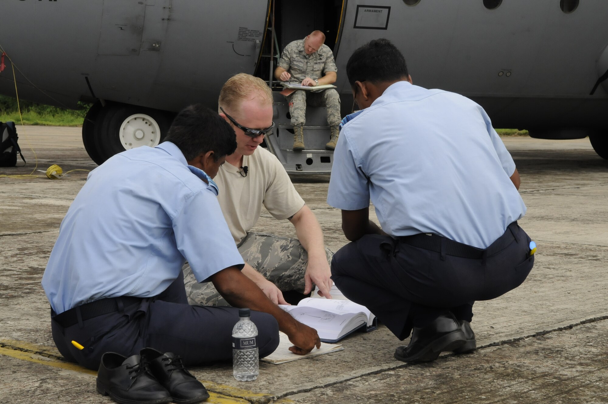 Staff Sgt. Kevin Stubblefield, an aircraft maintainer from the 374th Maintenance Squadron at Yakota Air Base, Japan, discusses a maintenance problem with Military Warrant Officer Abdul Jalil and Military Warrant Officer Golam Faruque, both Bangladesh Air Force aircraft maintainers, during exercise Cope South 10 on Sept. 20, 2010. The bilateral exercise’s subject-matter expert exchanges in maintenance, operations and rigging disciplines strengthen the strong and growing partnership between the United States and Bangladesh. Two C-130s from Yokota AB, and an AN-32 from Kurmitola Air Base are participating in Cope South 10.  (U.S.  Air Force photo / Master Sgt. Jeffery Loftin)