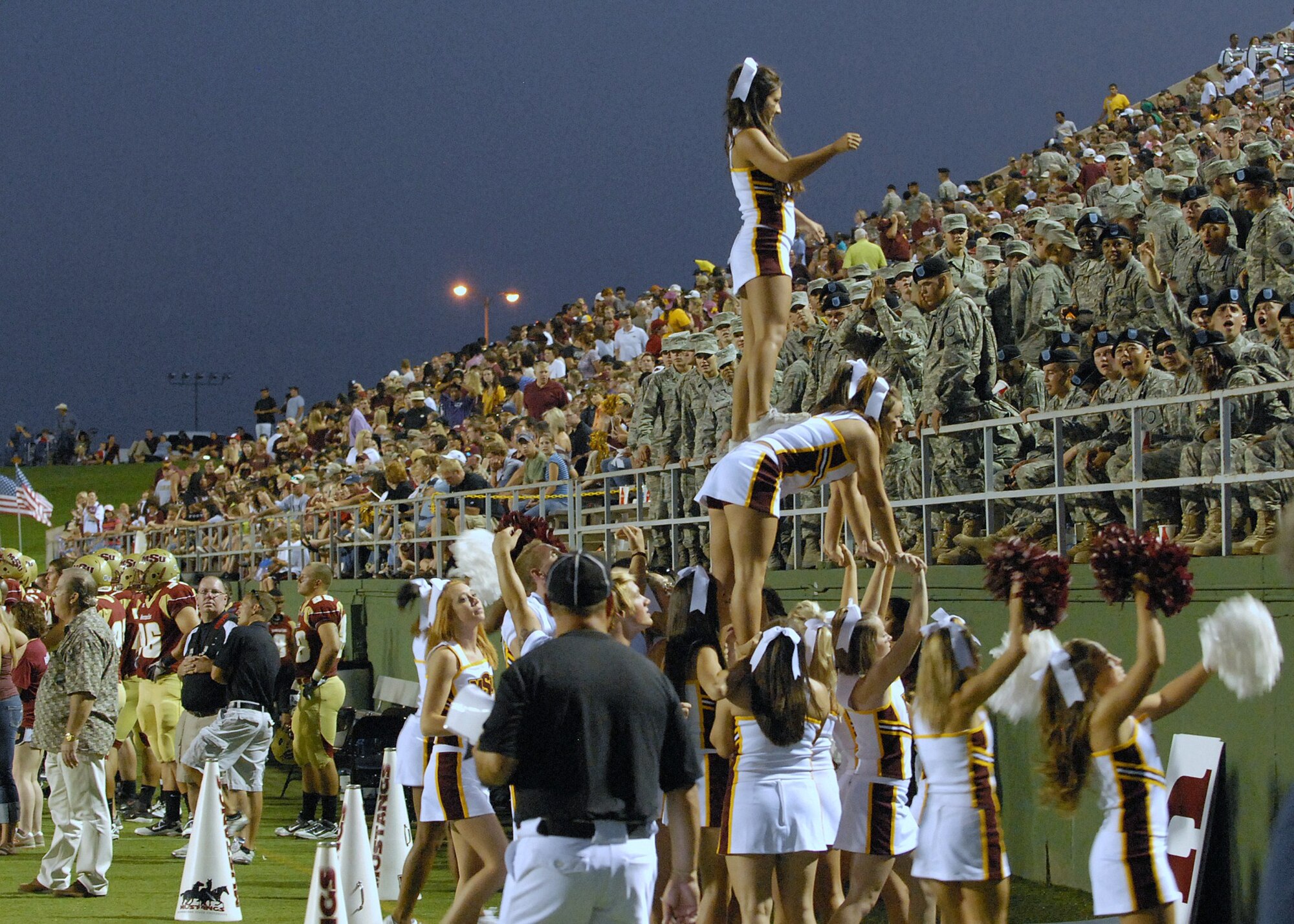 Midwestern State University cheerleaders pay tribute to area military servicemembers as they host the annual MSU Military Appreciation Game at Memorial Stadium in Wichita Falls, Texas Sept. 18.  The game featured an opening flyover and a patriotic halftime show.  The MSU Mustangs defeated Southwestern Oklahoma 46-9.  (U.S. Air Force photo/LouAnne Sledge)