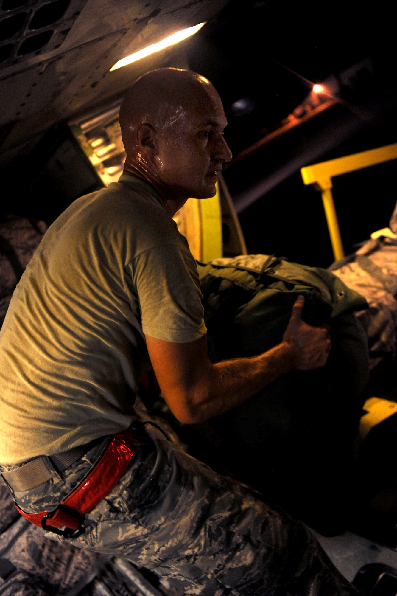 MOODY AIR FORCE BASE, Ga. -- Airman 1st Class Daniel Hugo, 23rd Aircraft Maintenance Squadron, loads baggage into a belly compartment of a commercial aircraft here. Bags were loaded for three straight hours to prepare for a deployment. (U.S. Air Force photo/Airman 1st Class Benjamin Wiseman)




